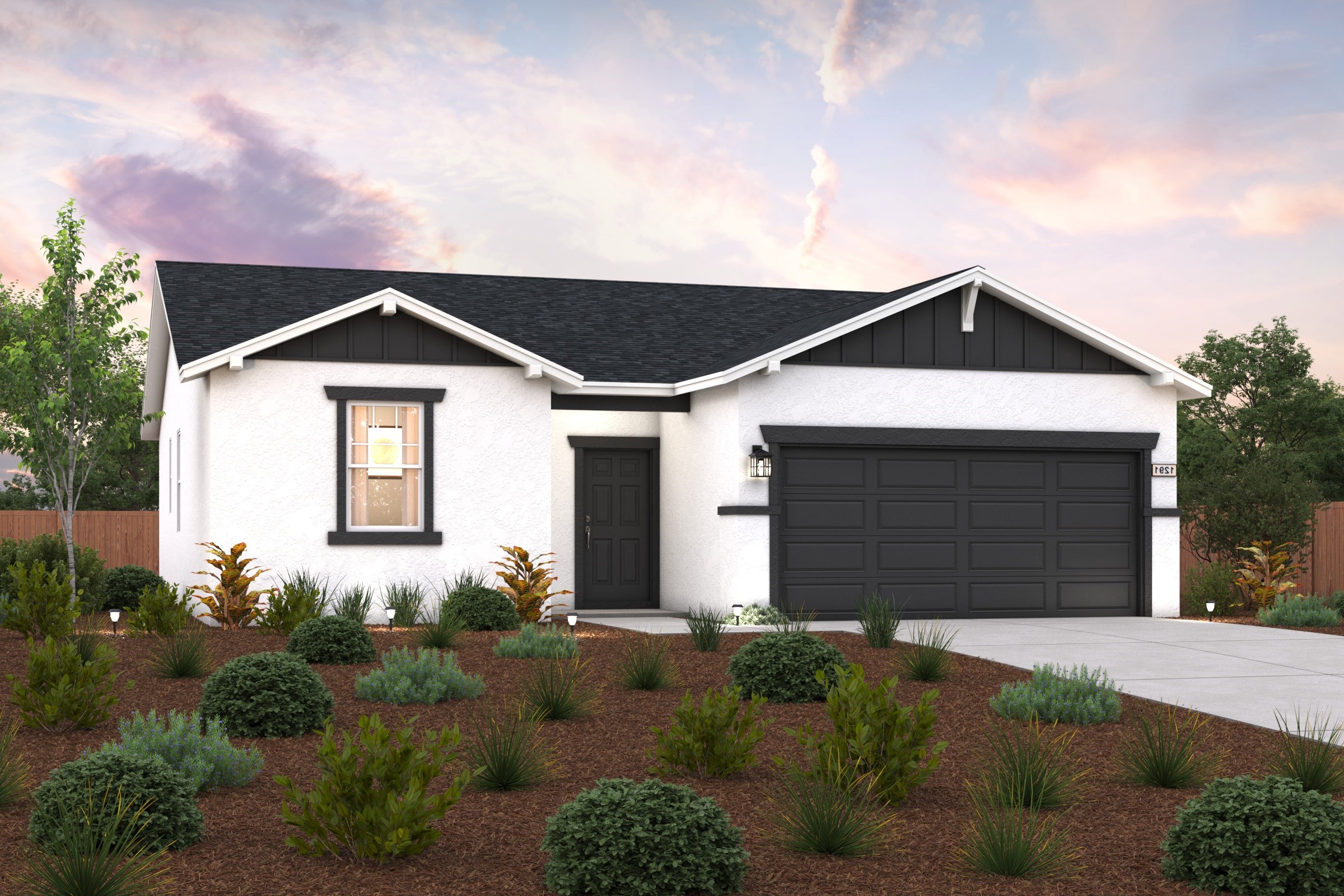 A house with a garage and bushes in front of it.