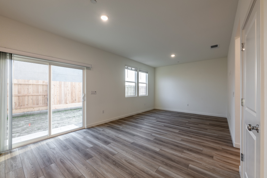 A room with a wood floor and windows.
