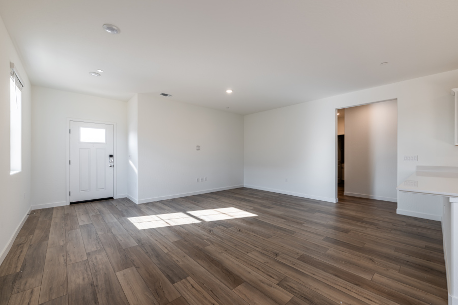 A room with a wood floor and white walls.
