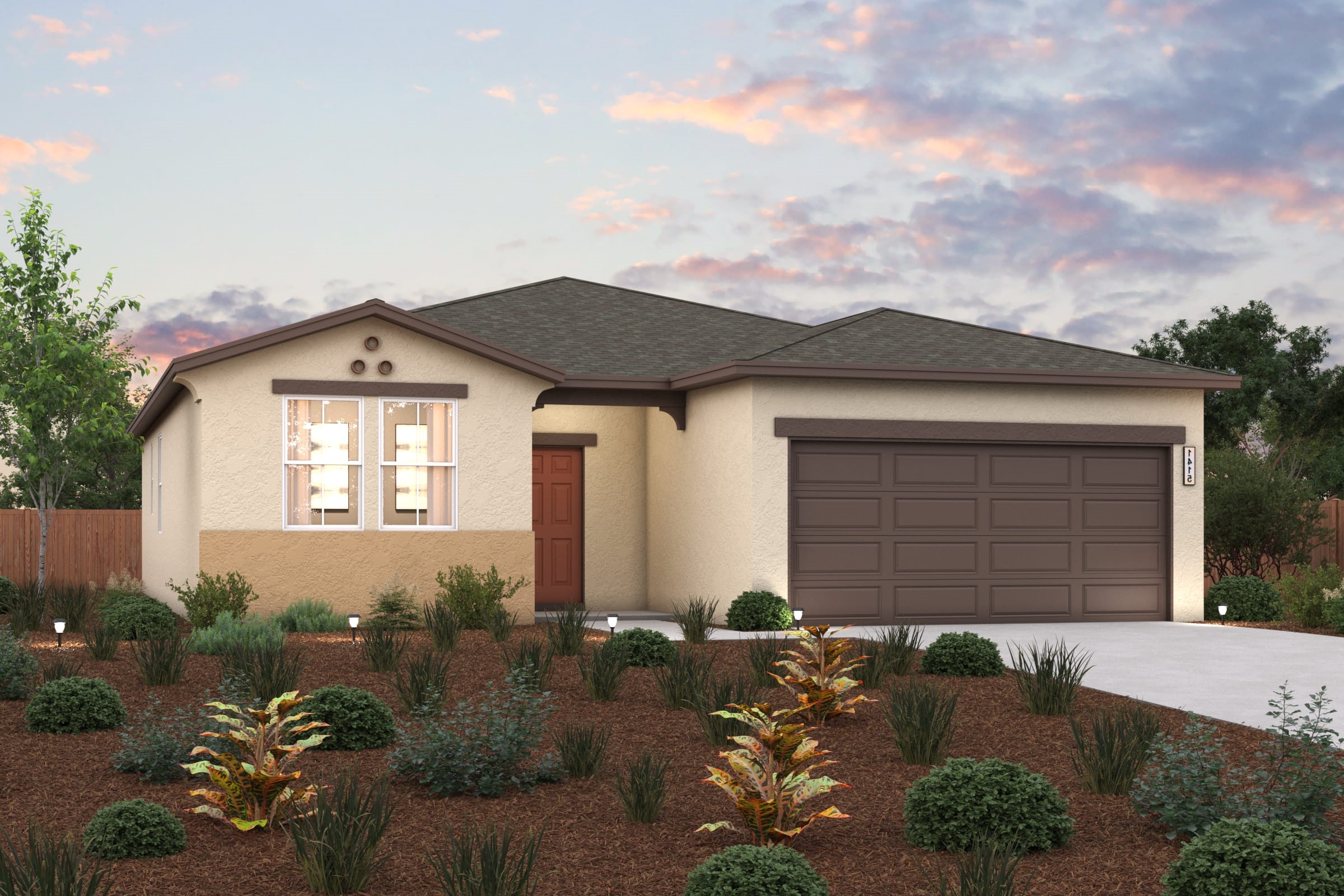 A house with a garage and bushes in front of it.