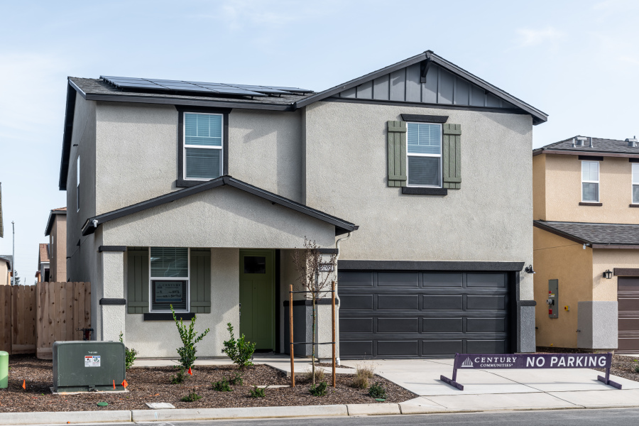 A grey house with a garage.