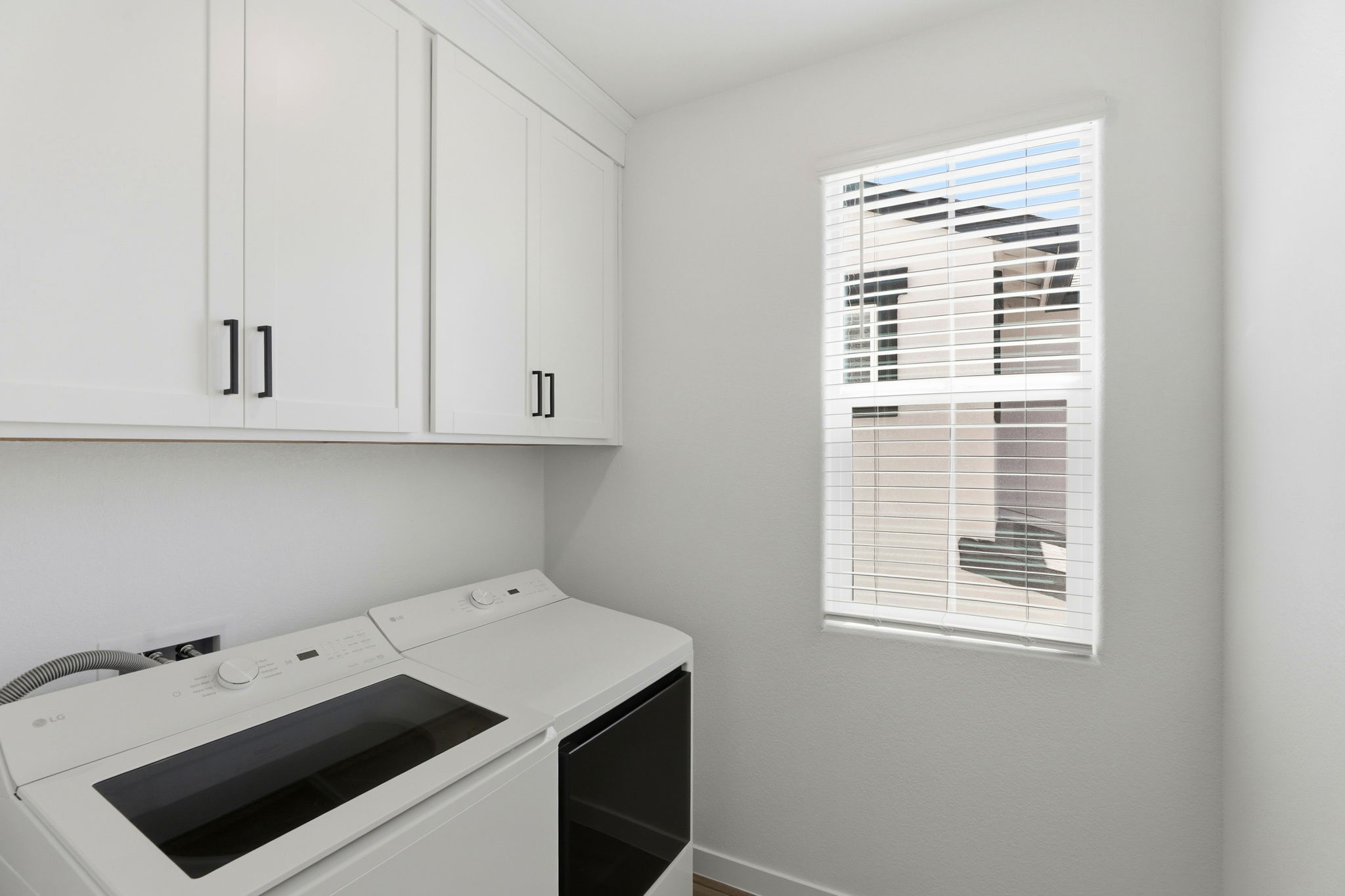 A kitchen with white cabinets.