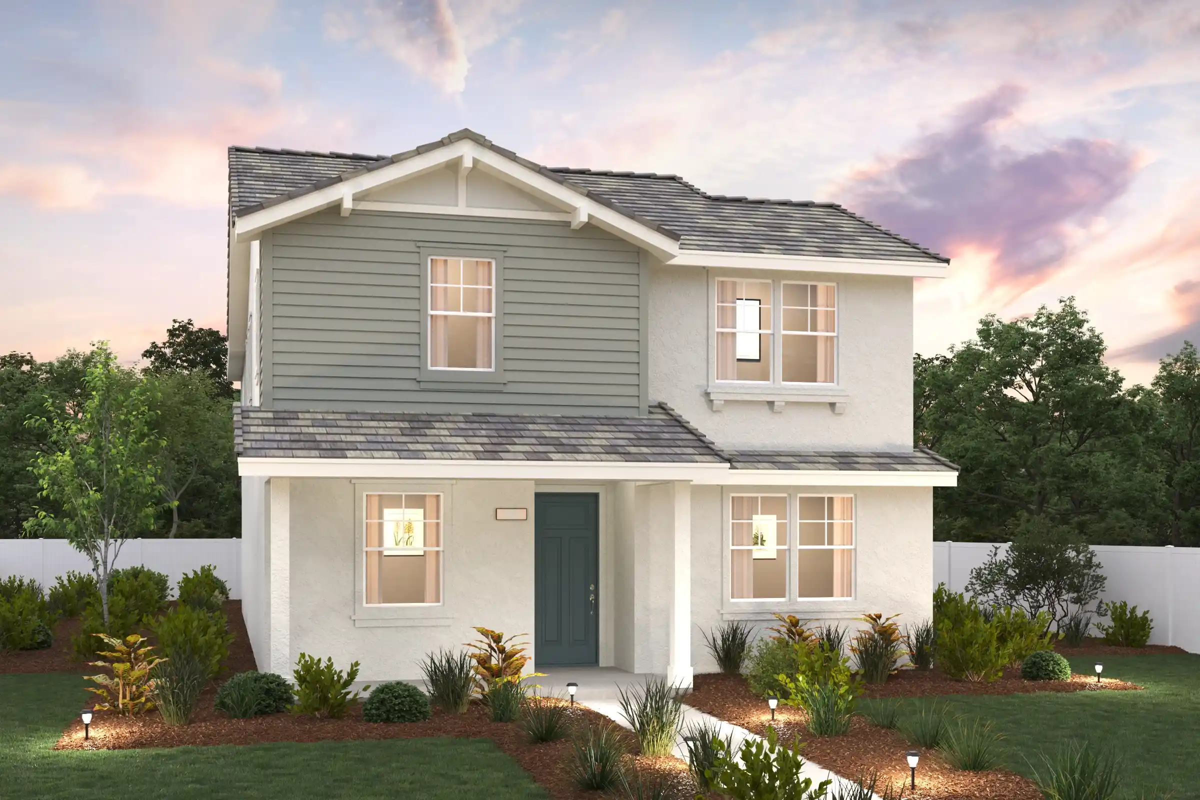 A white house with a green lawn.