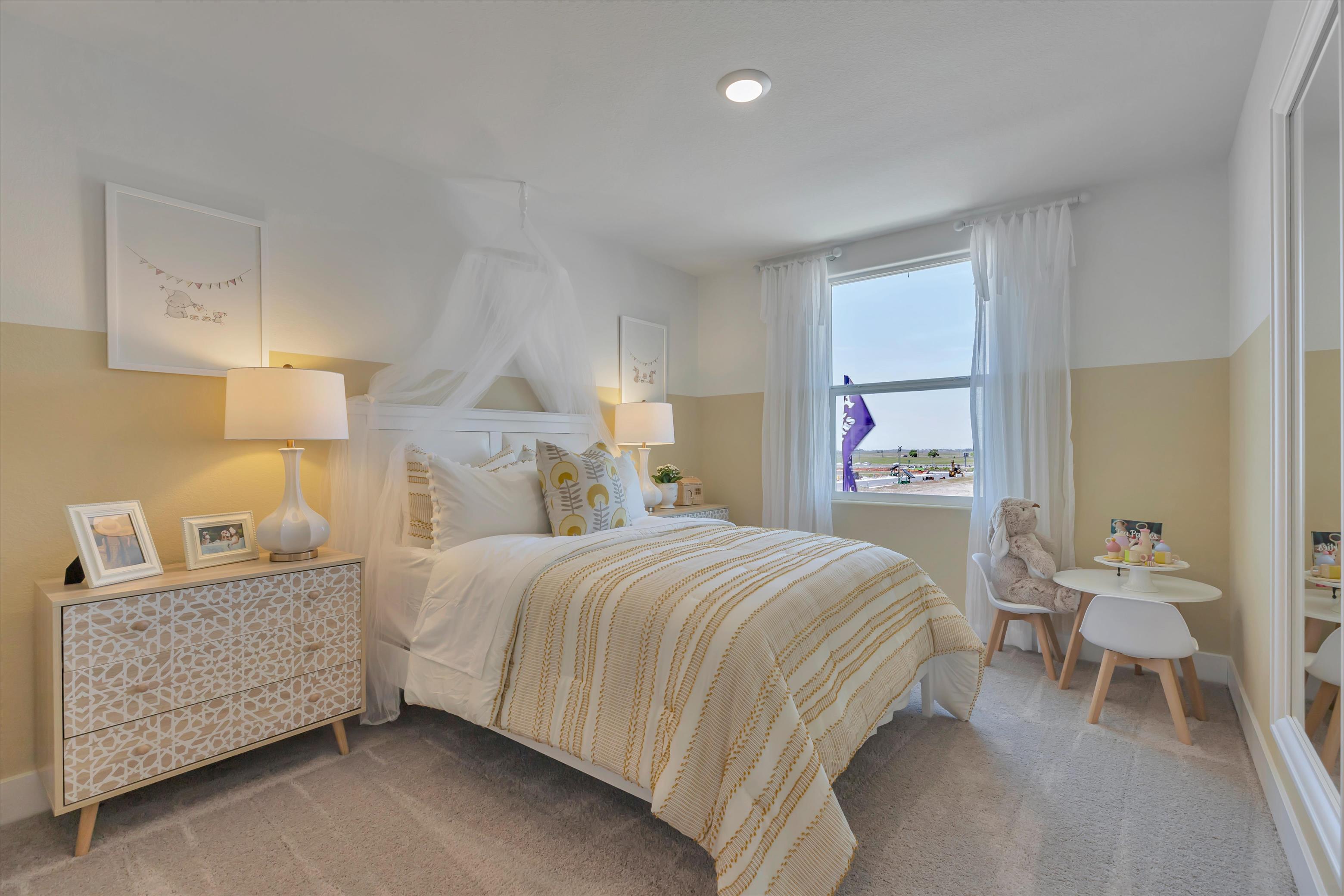 A bedroom with a bed and a desk.