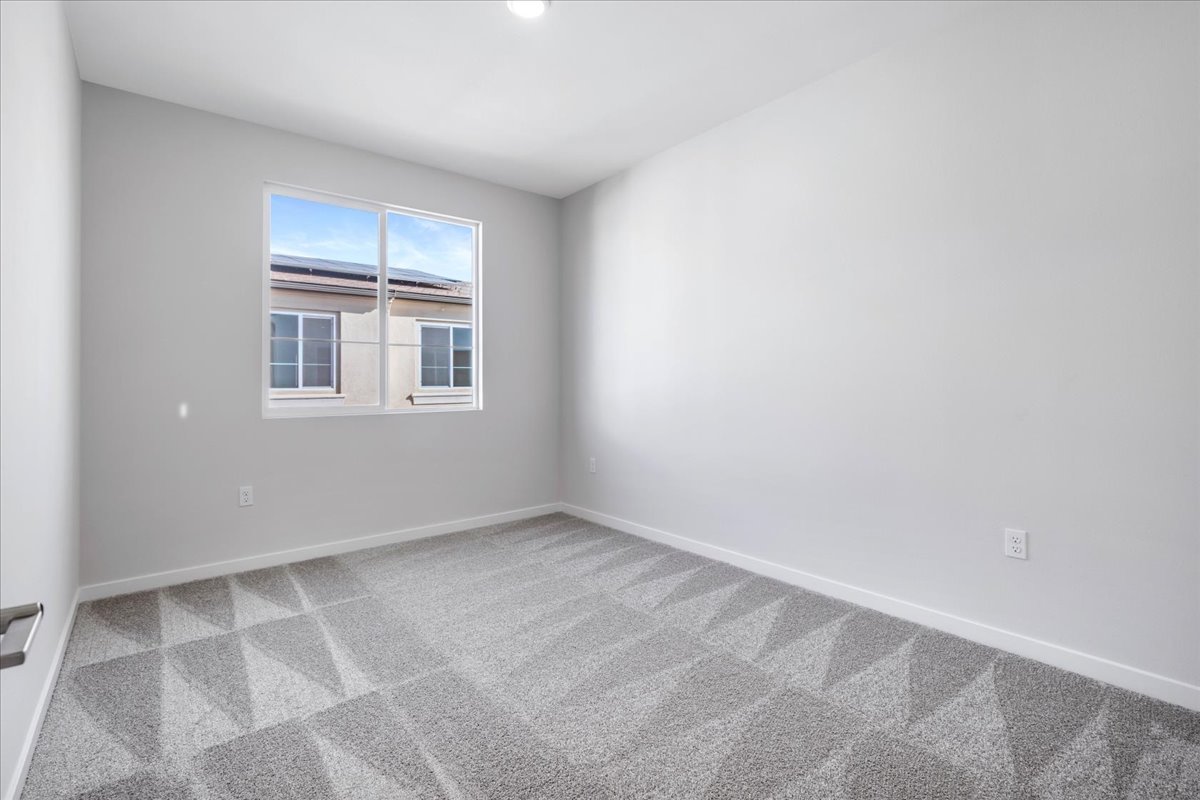 A room with a window and a tile floor.