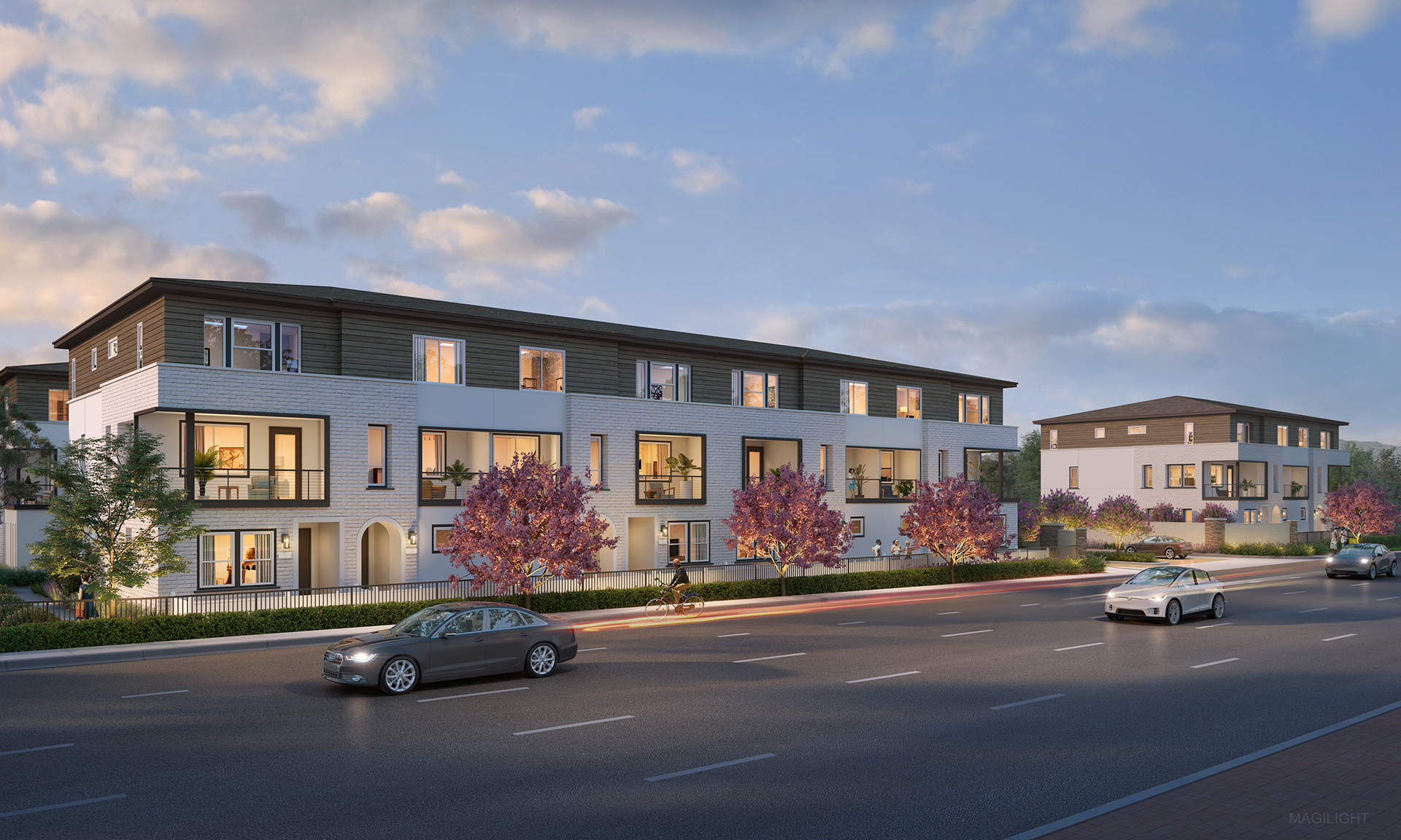 A street with cars and buildings along it.