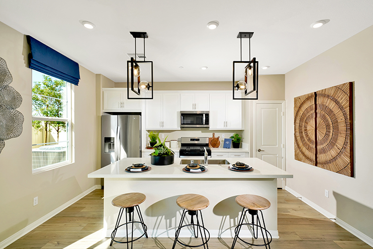 A kitchen with a table and stools.