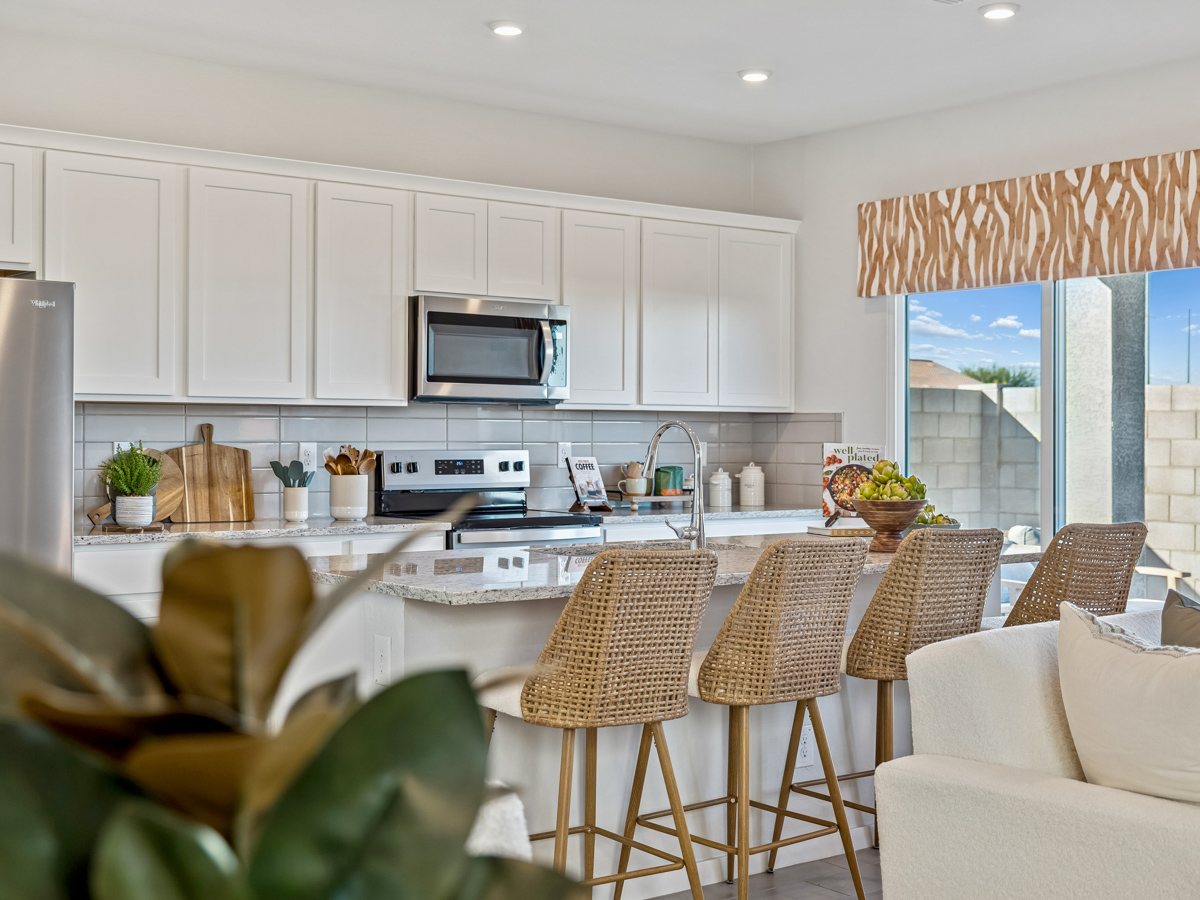 A kitchen with white cabinets.