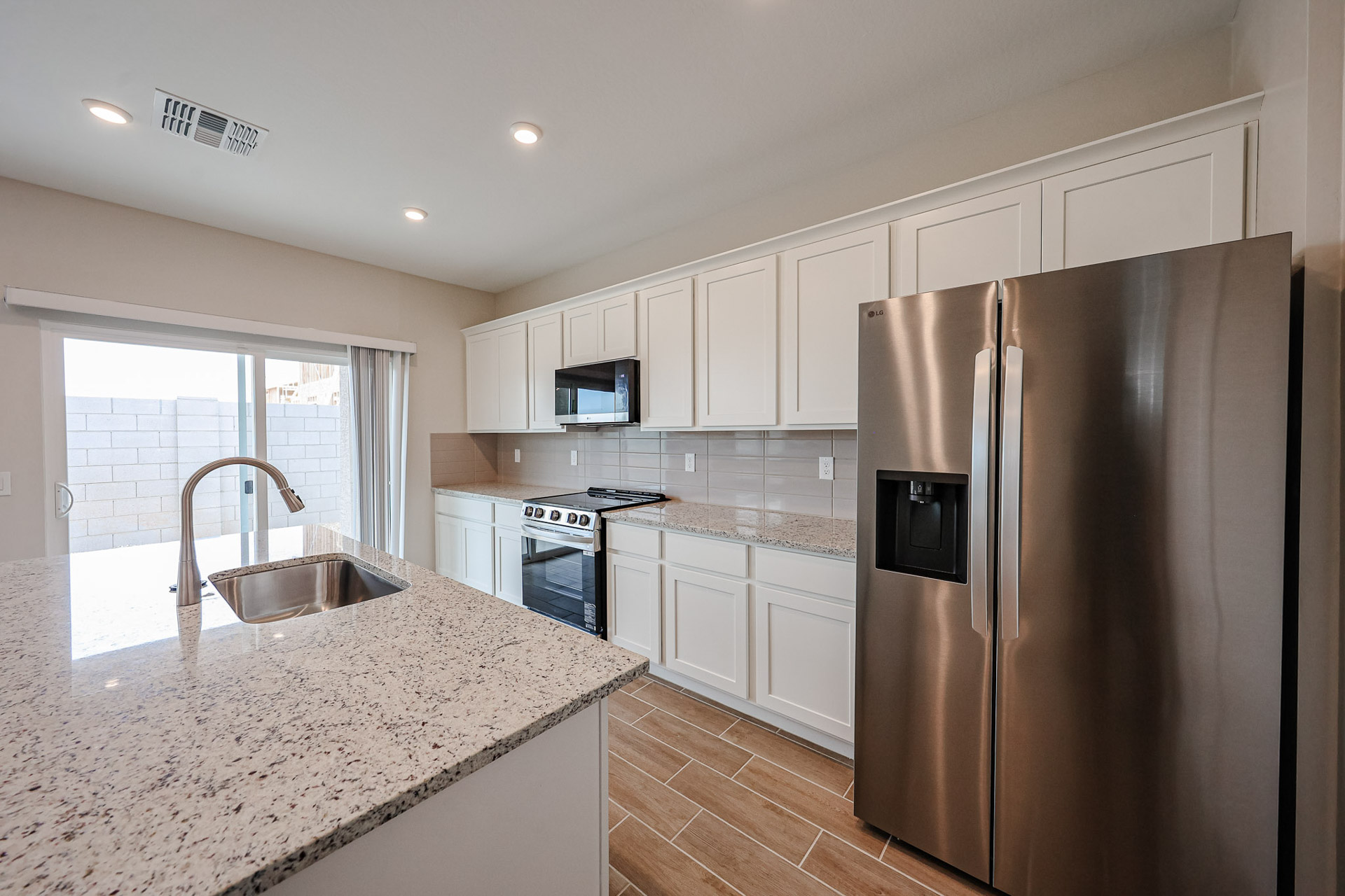 A kitchen with white cabinets.