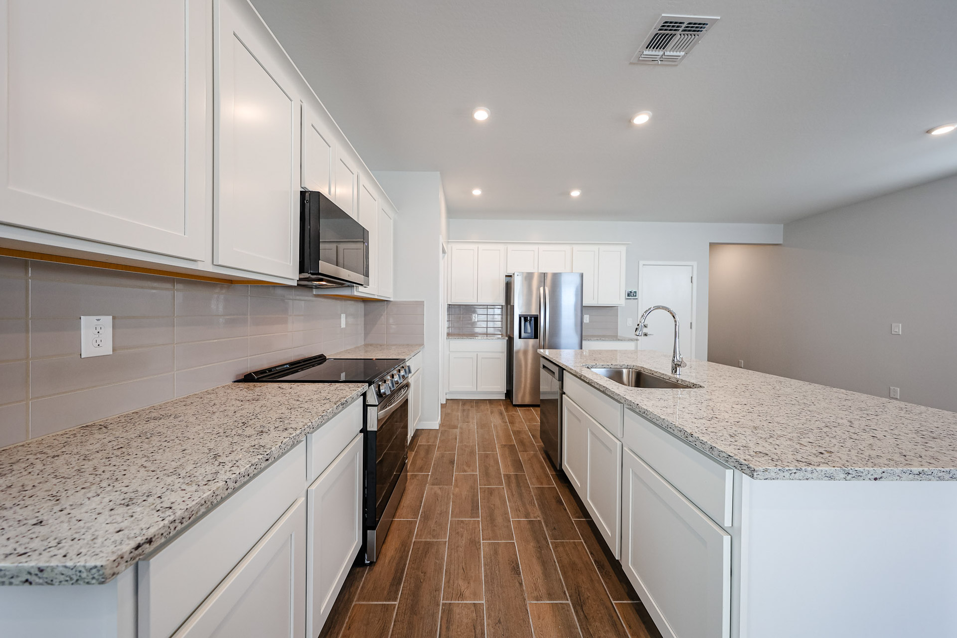 A kitchen with white cabinets.