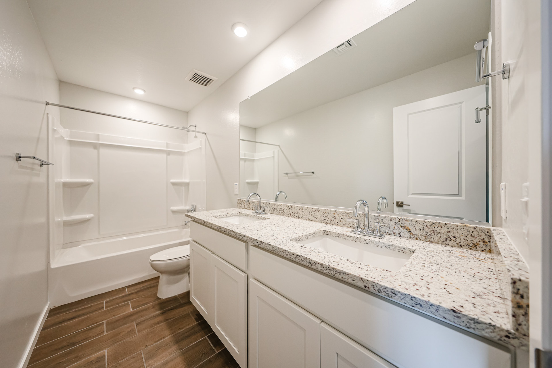 A bathroom with a tub sink and toilet.