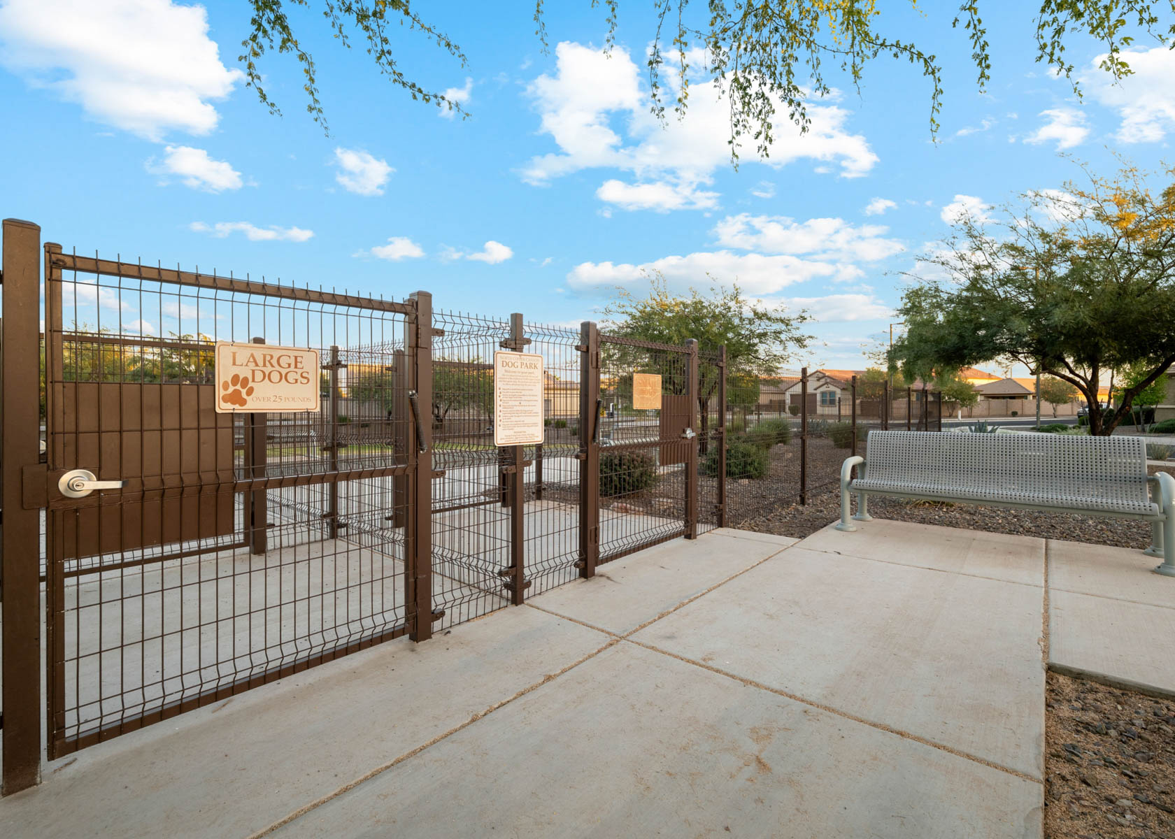 A black gate with a sign on it.