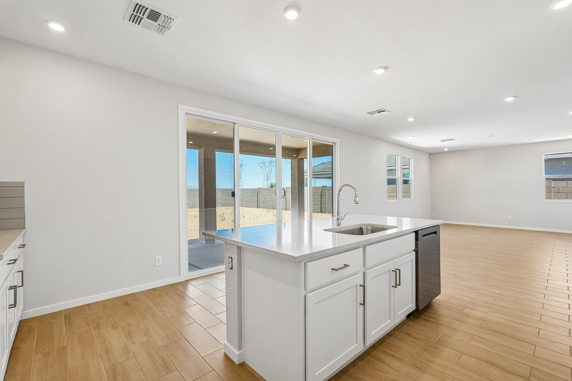 A kitchen with white cabinets.