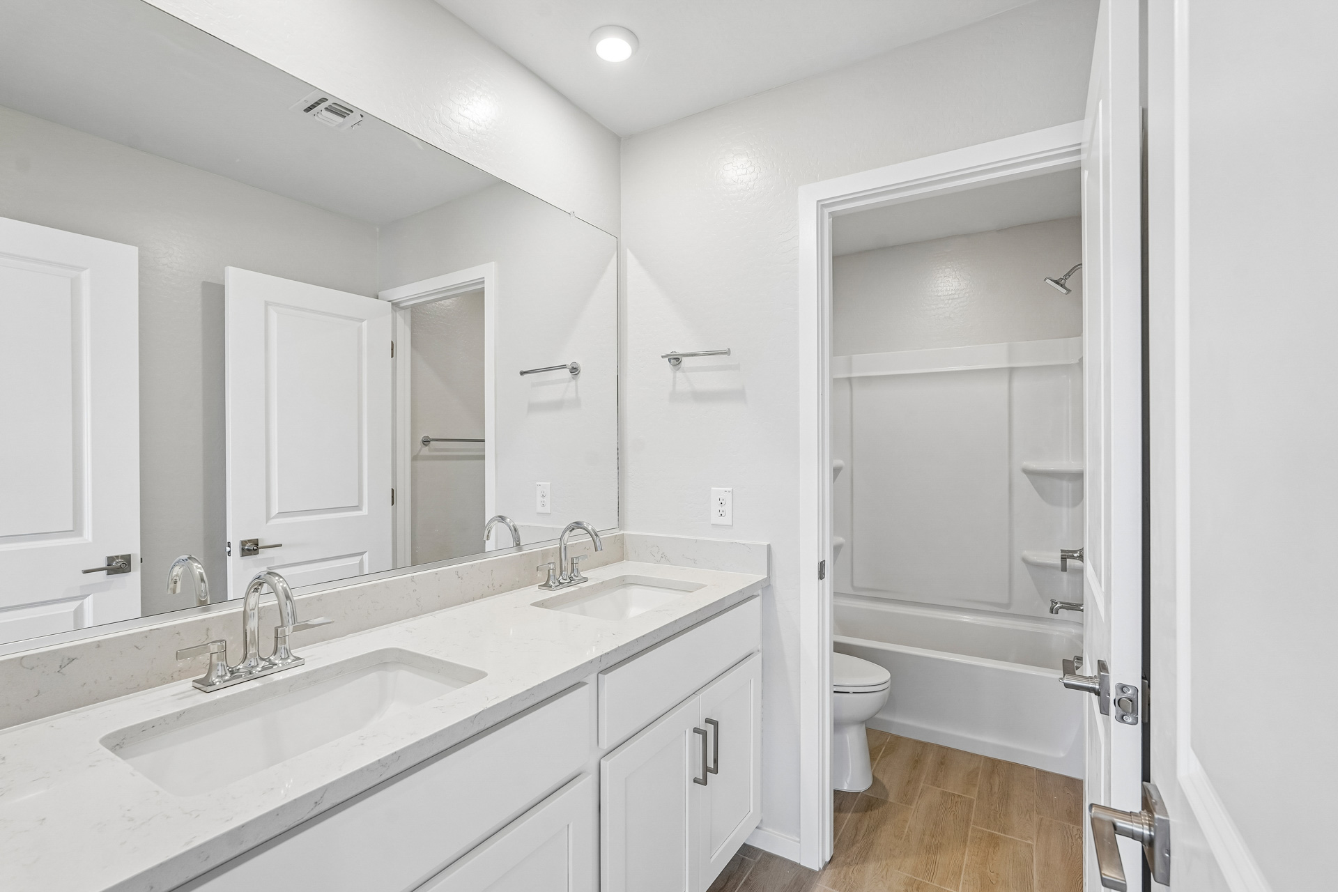 A bathroom with a tub sink and toilet.