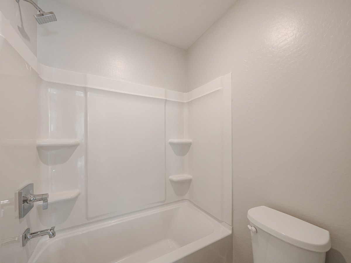 A bathroom with a tub toilet and sink.