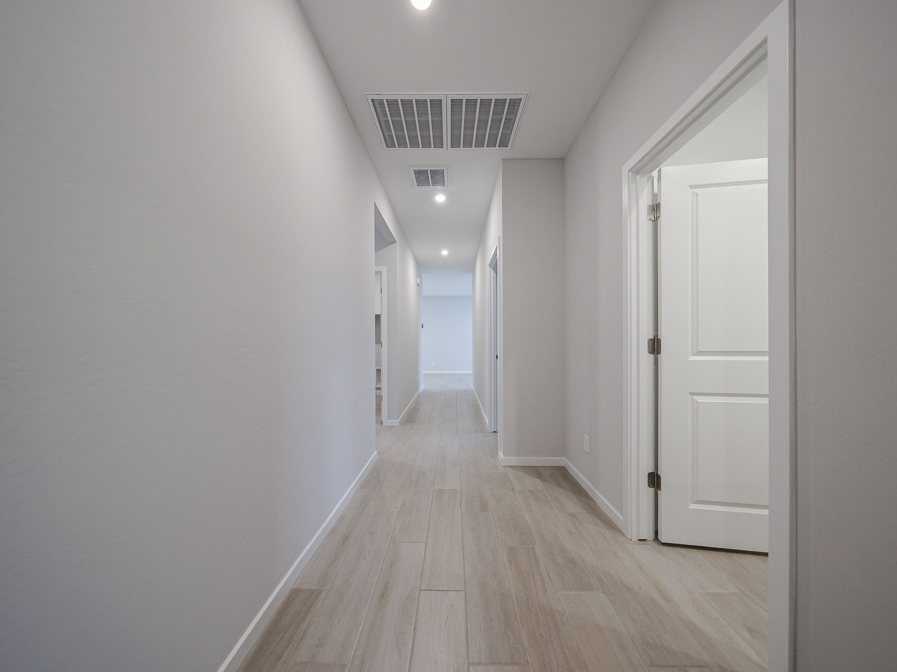 A hallway with white doors.