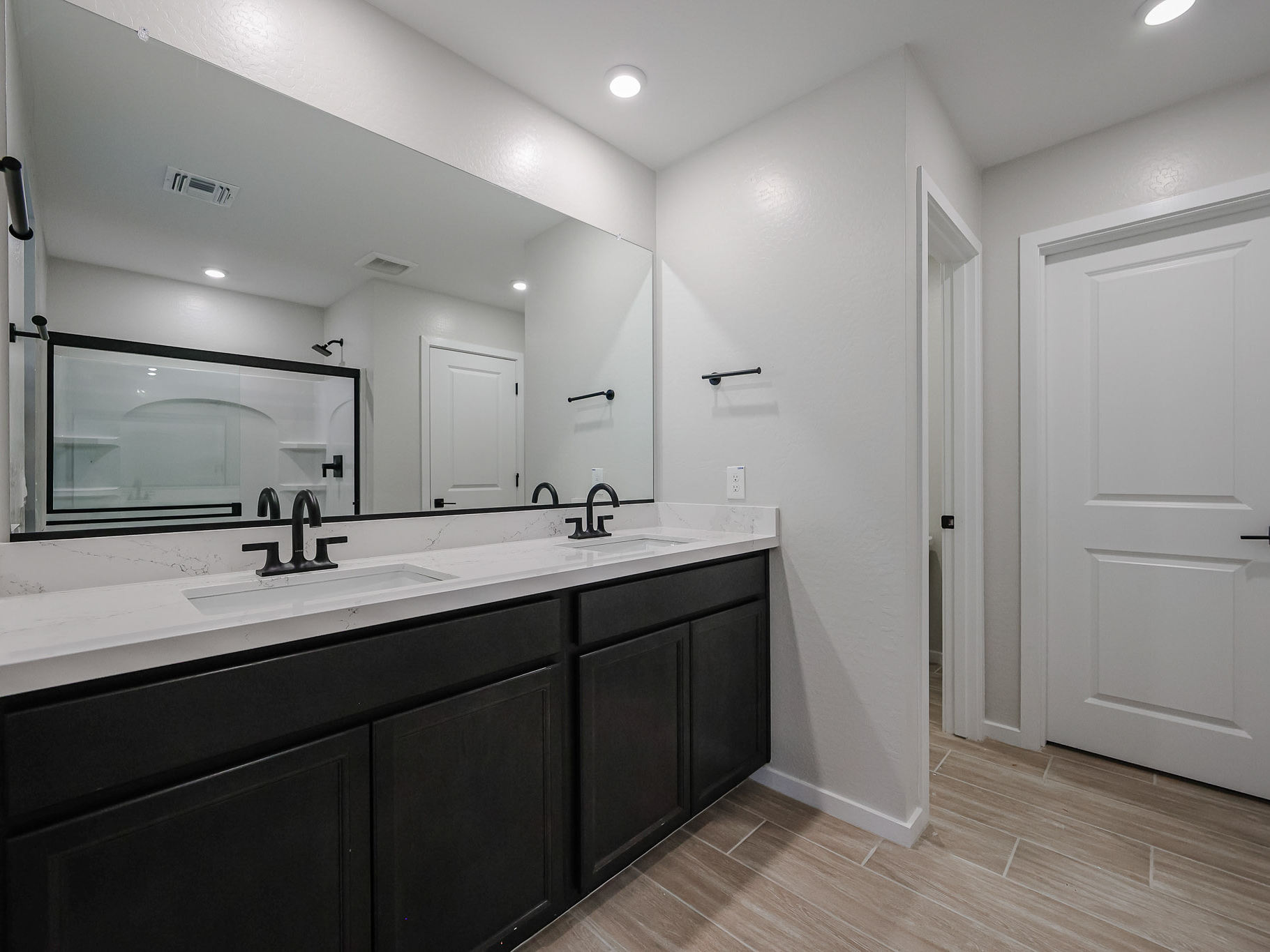 A bathroom with a large mirror.