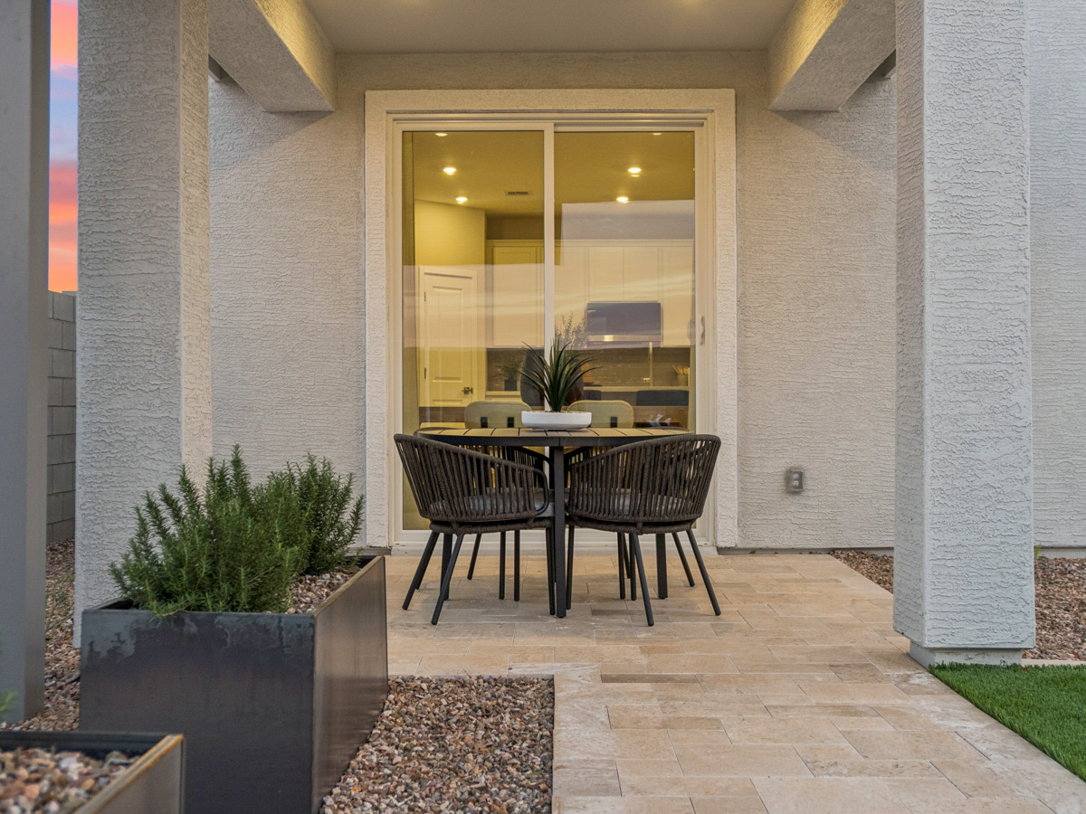 A table and chairs outside a building.