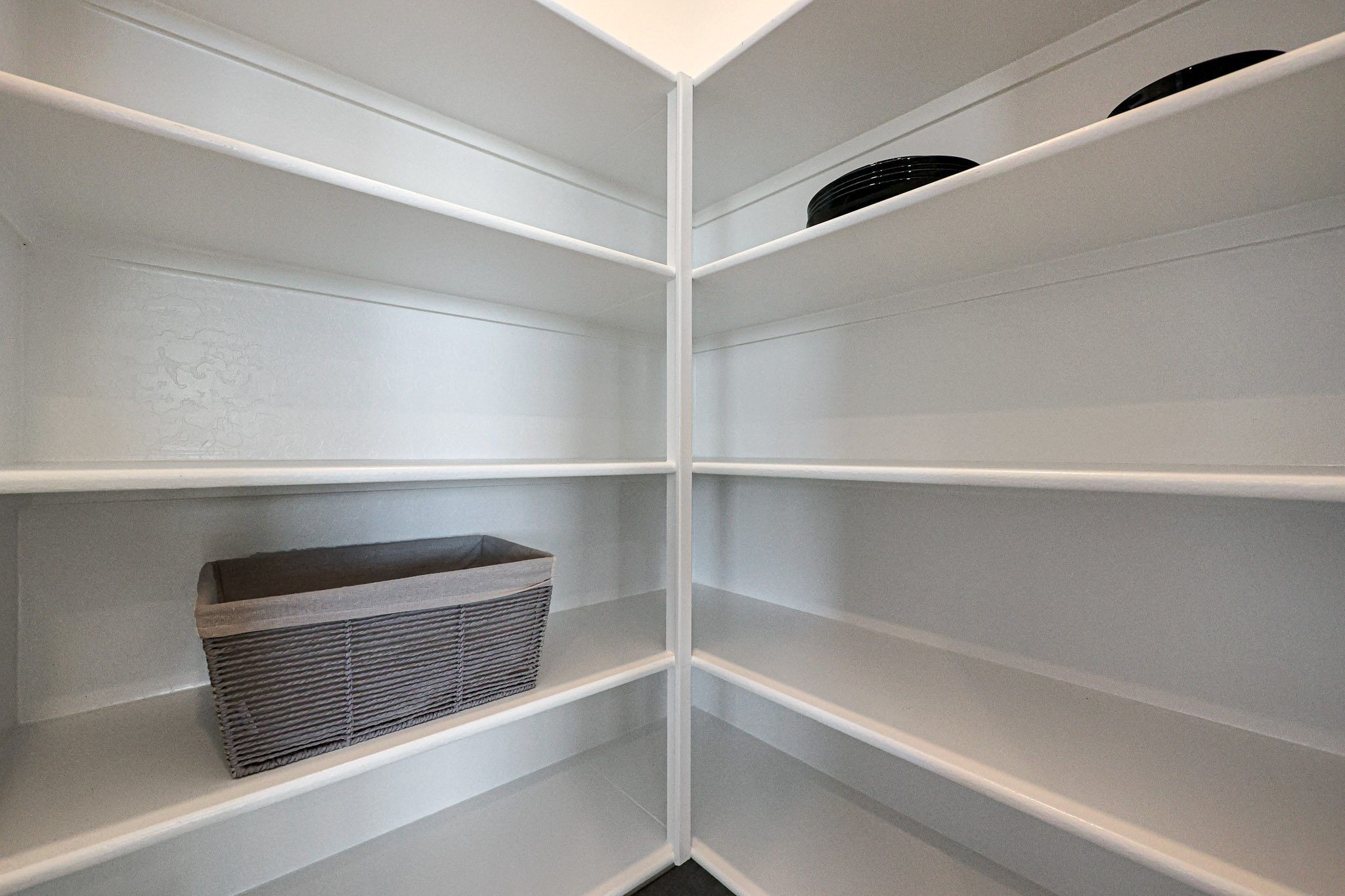 A white shelf with a vent.