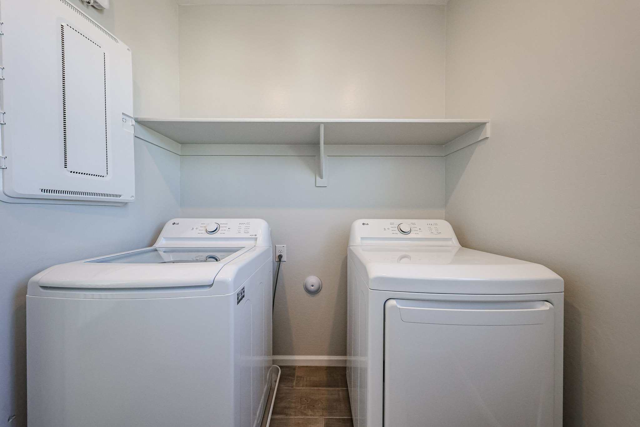 A washing machine and dryer in a room.