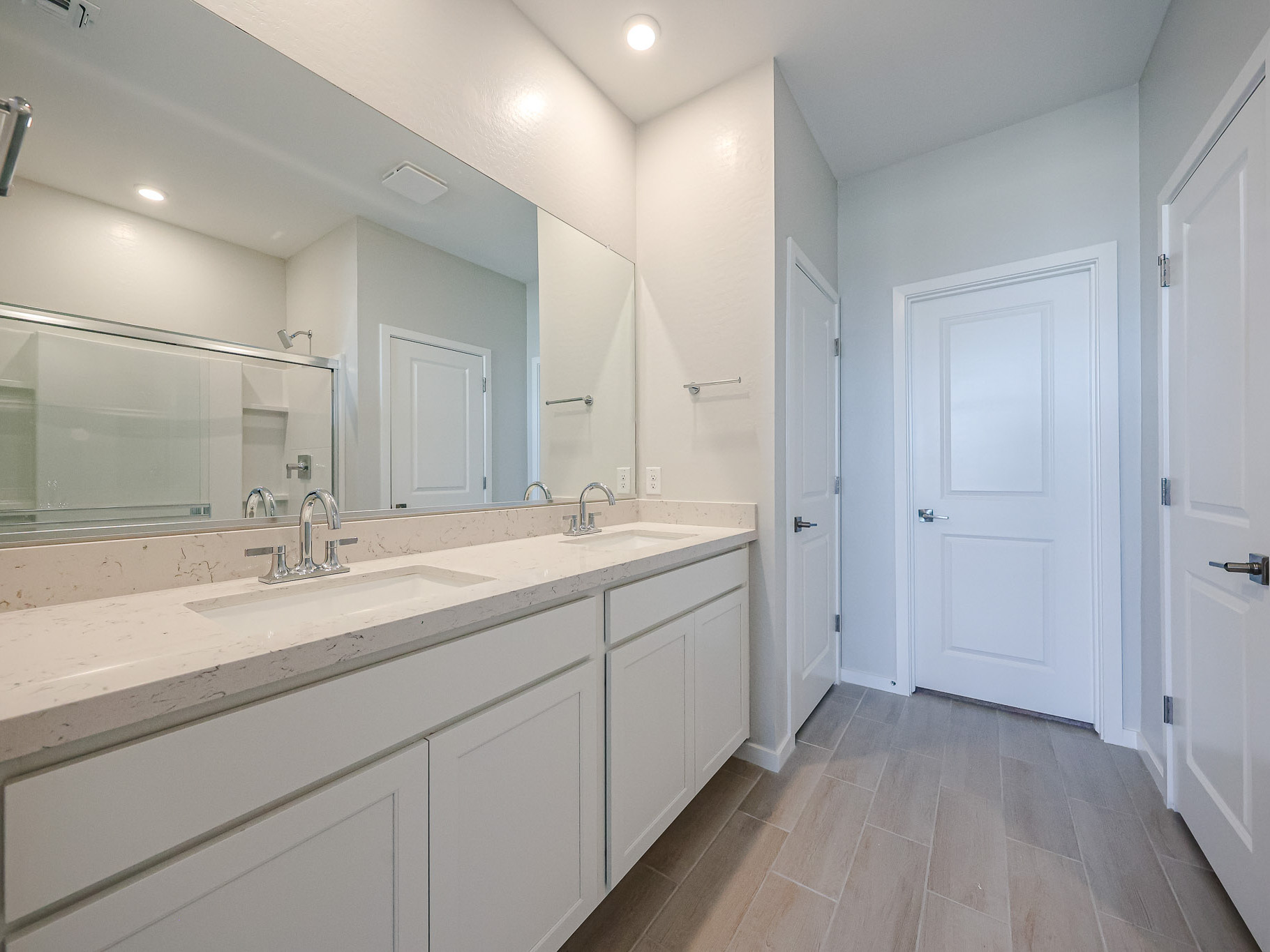 A bathroom with white cabinets.