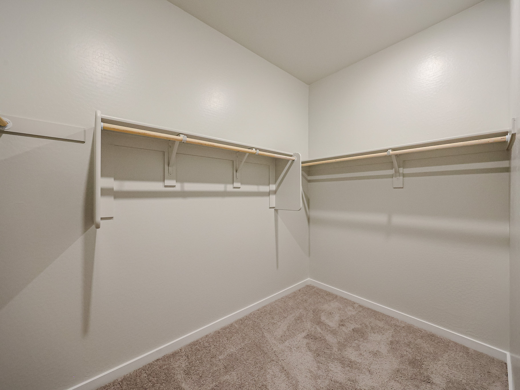 A white room with a metal bar.