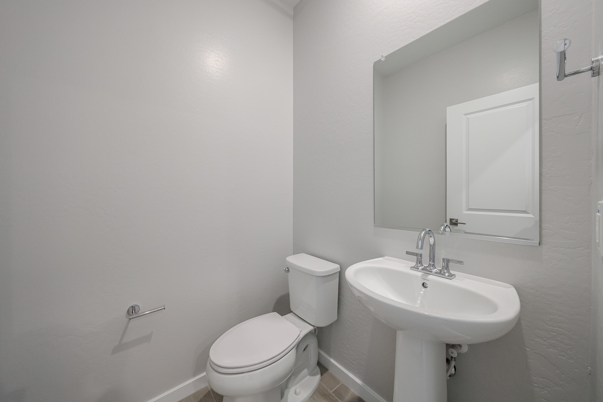 A bathroom with a toilet and sink.