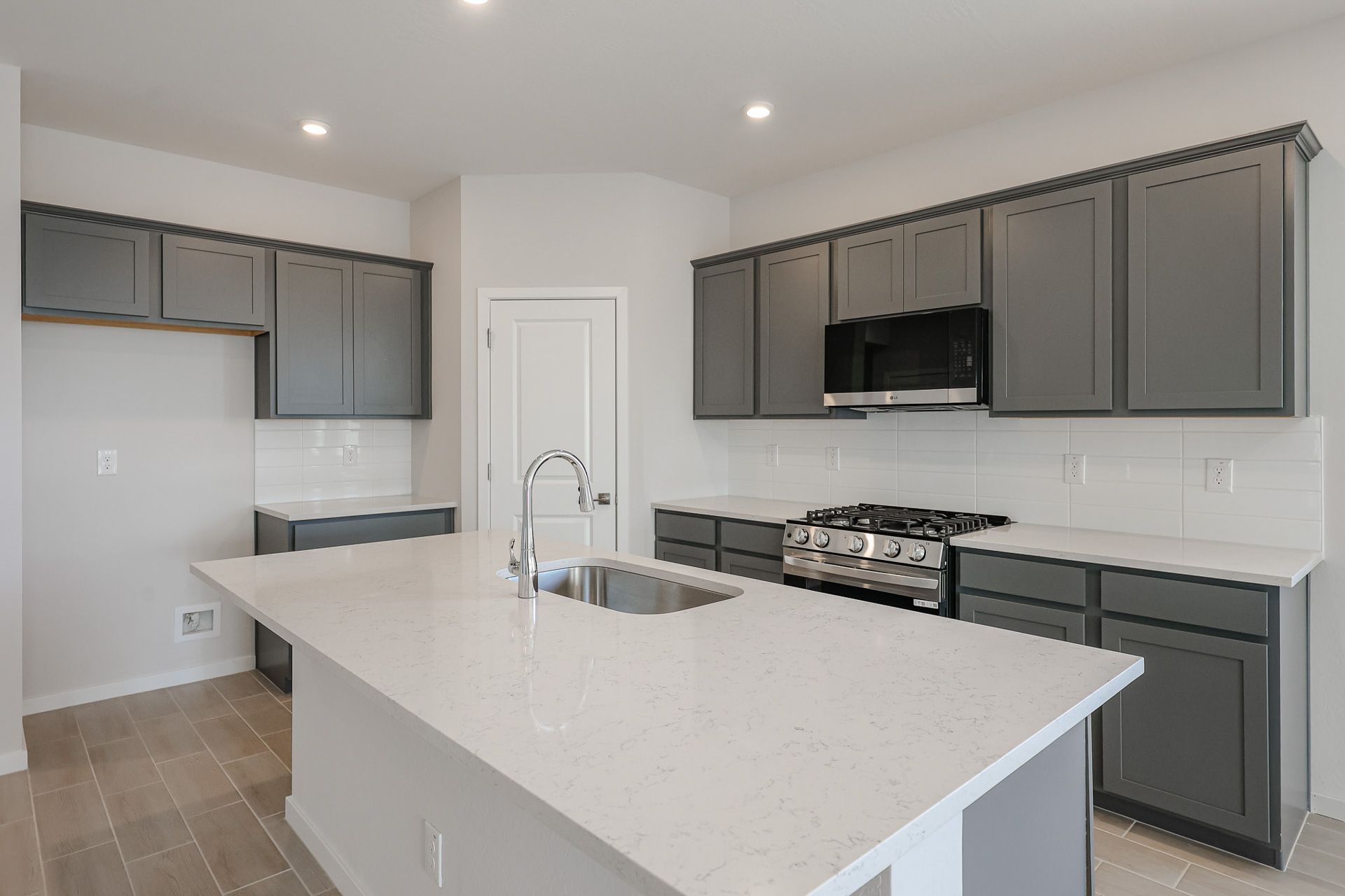 A kitchen with black cabinets.