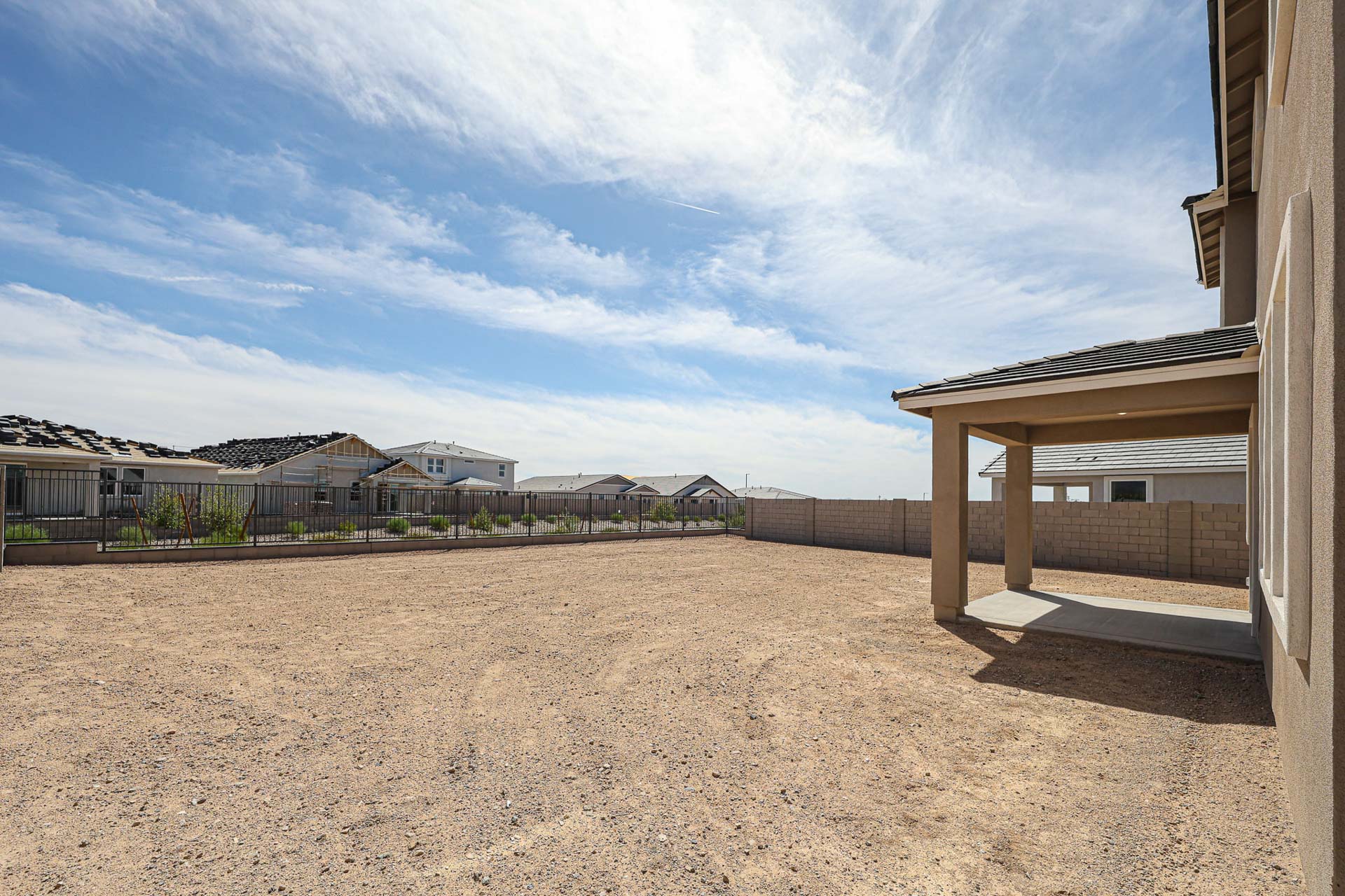 A sandy area with buildings in the background.