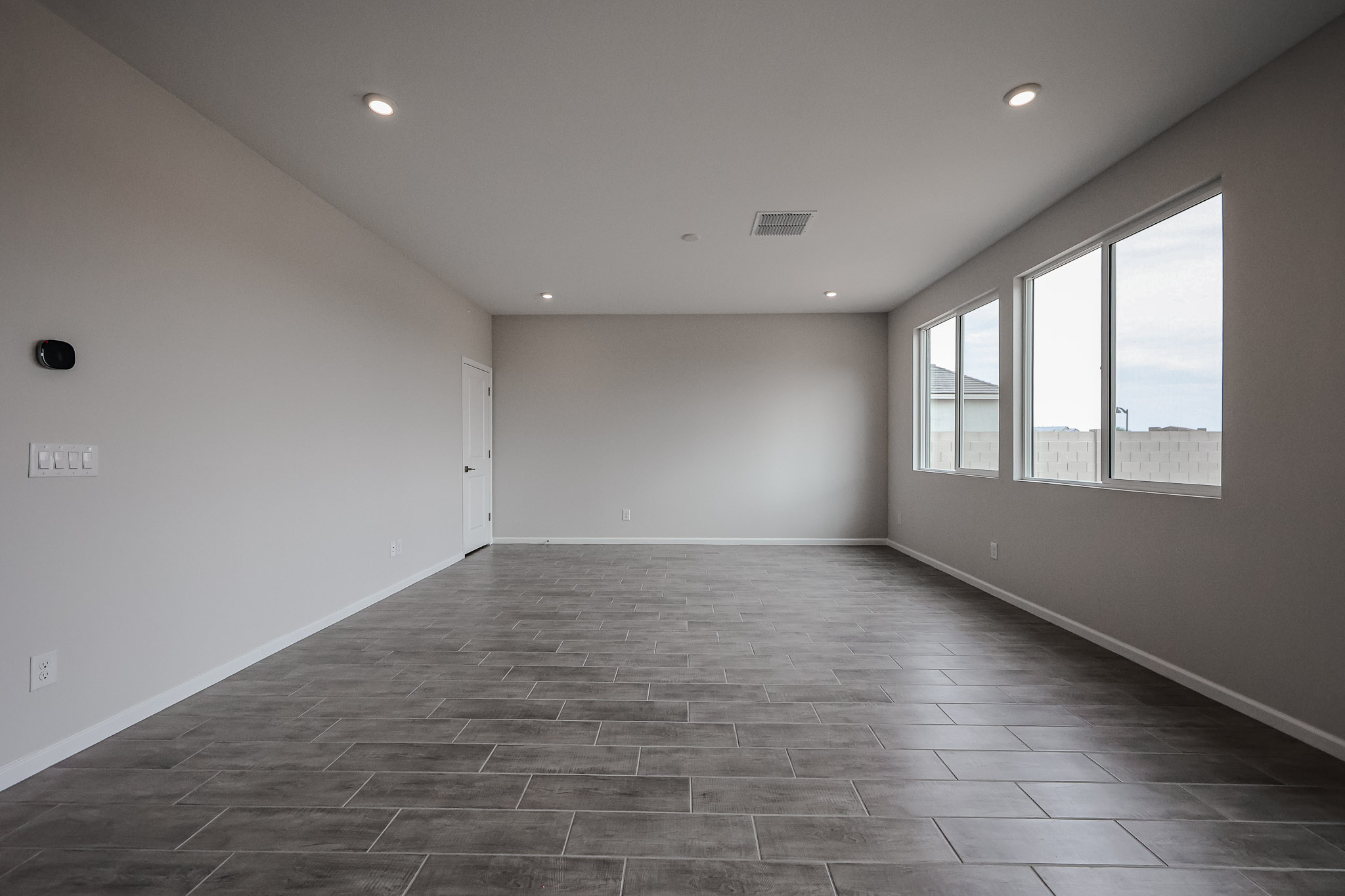 A room with a tile floor and windows.