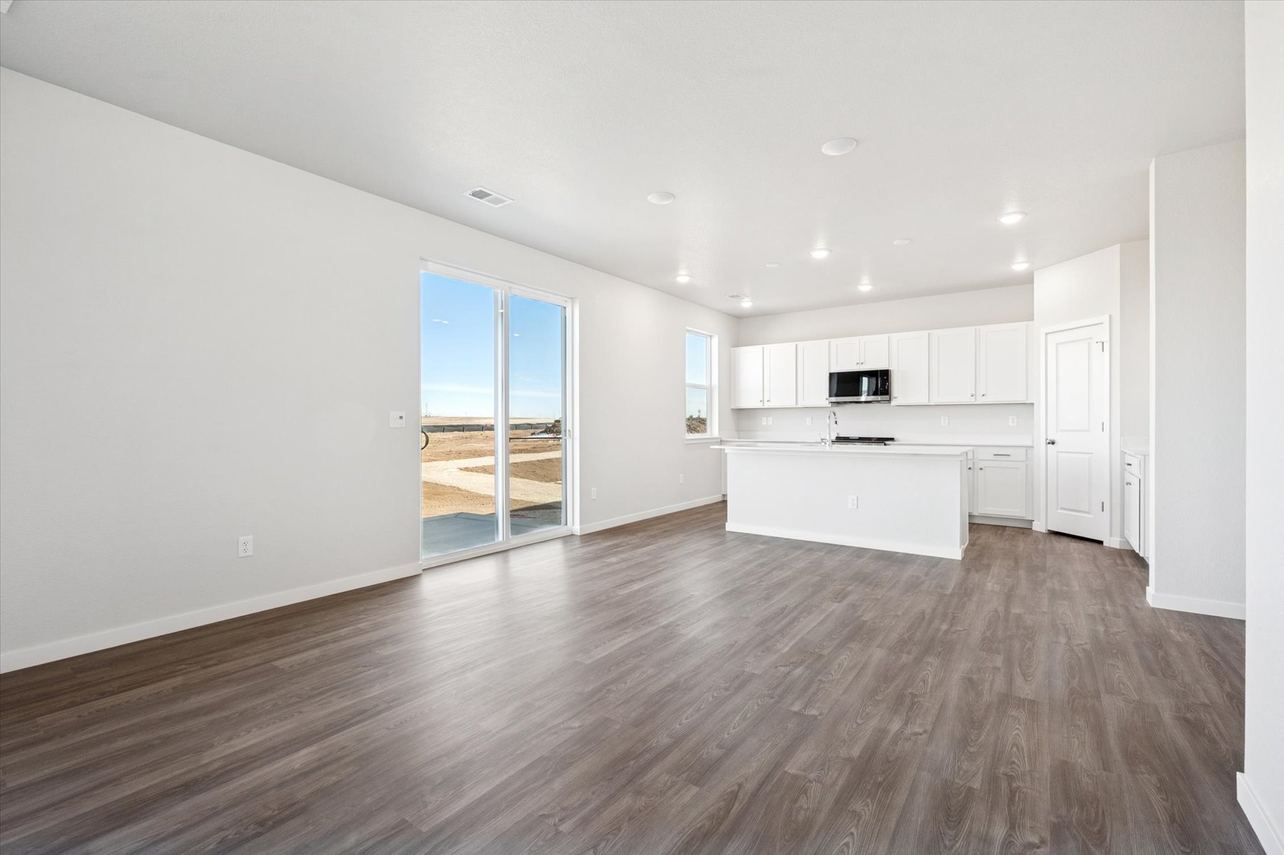 A large empty room with a large glass door.