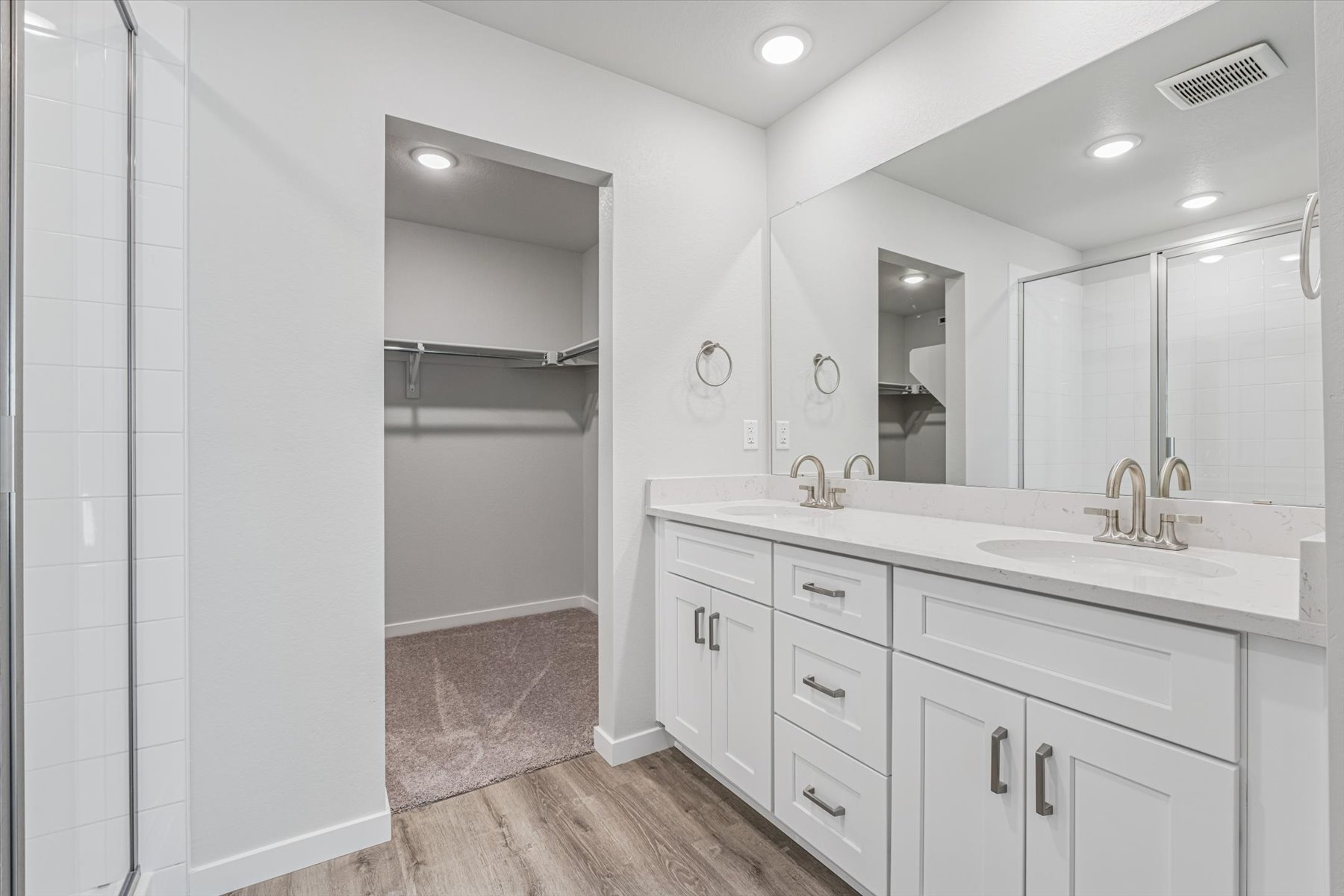 A bathroom with a shower and sink.