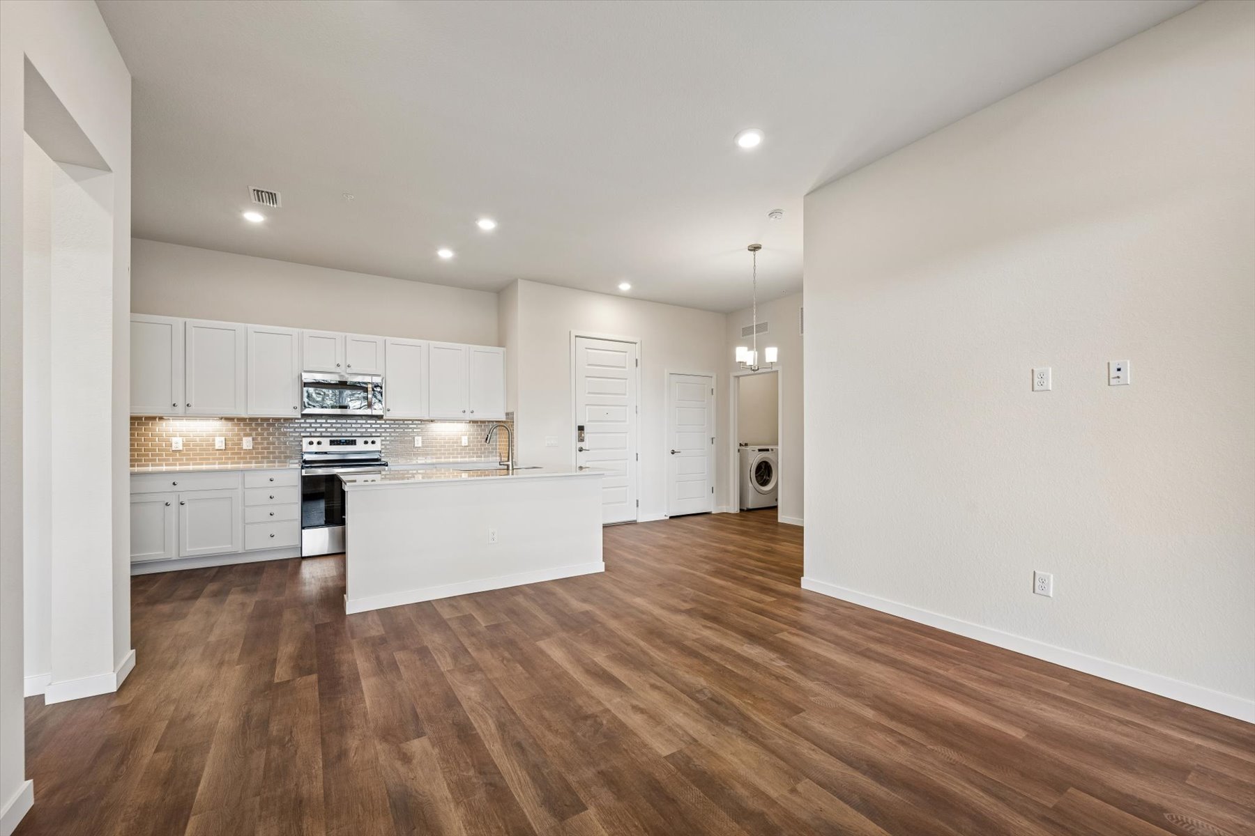 A kitchen with white cabinets.