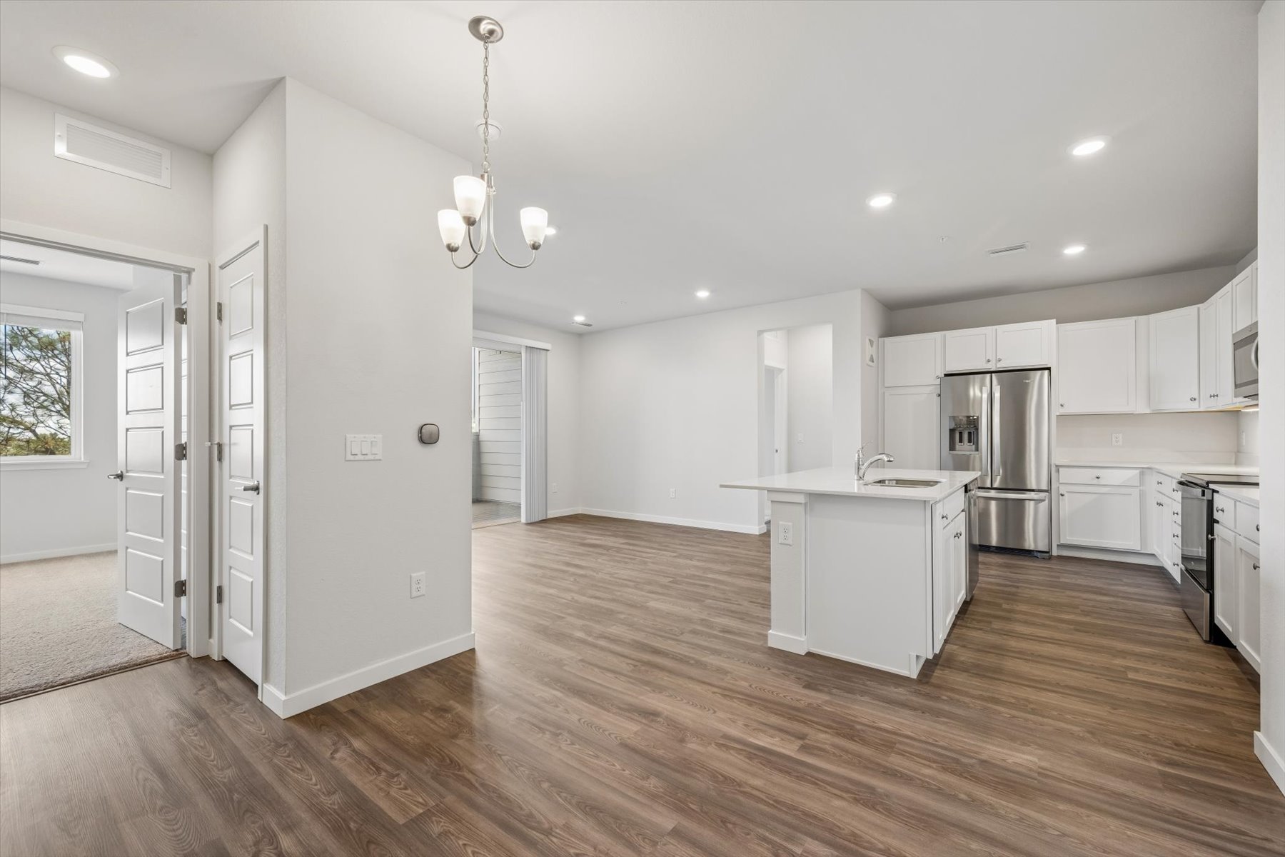 A kitchen with white cabinets.