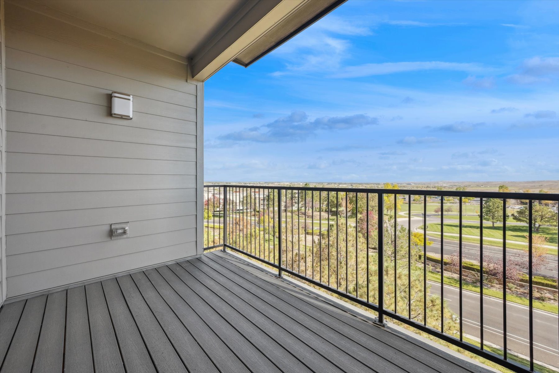 A deck with a view of the ocean and a building.