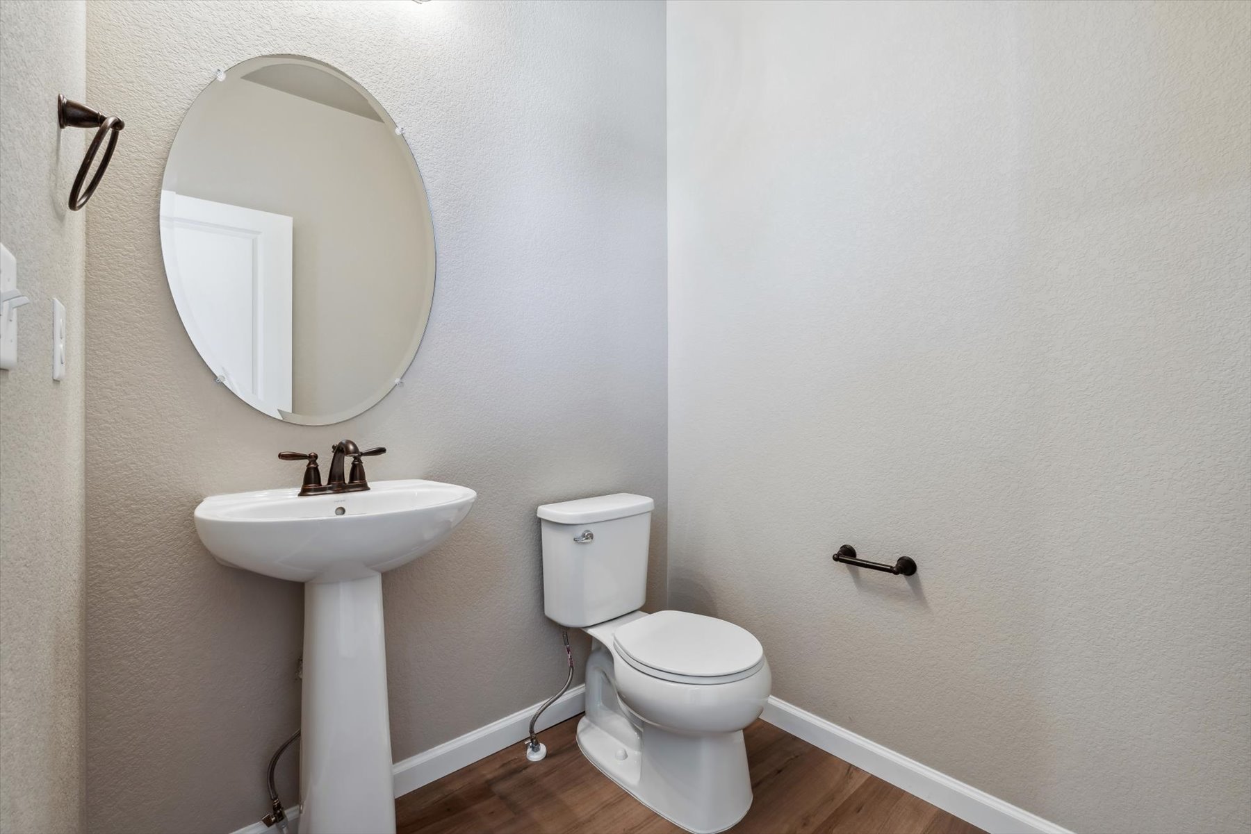 A bathroom with a round mirror.