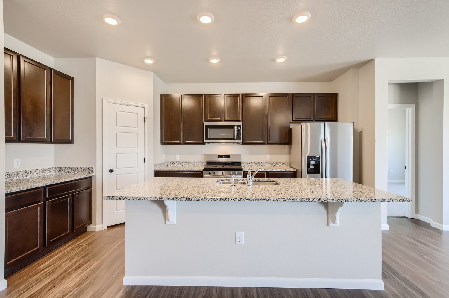 A kitchen with a marble counter top.