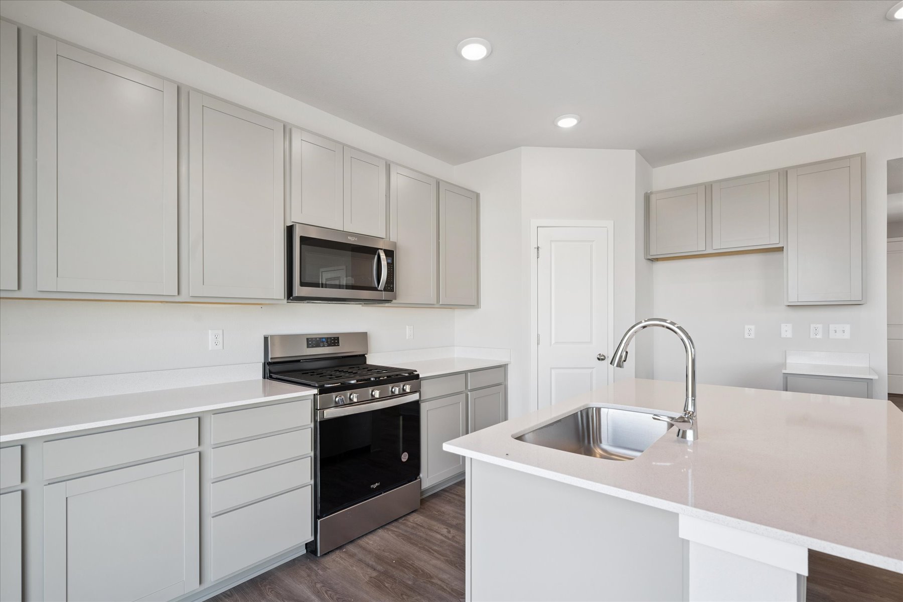 A kitchen with white cabinets.