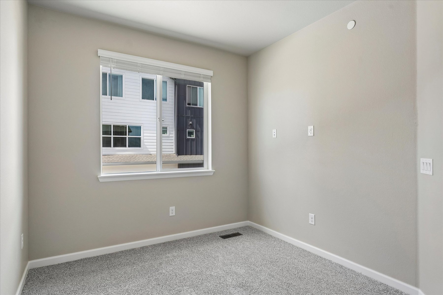 A room with a window and a door.