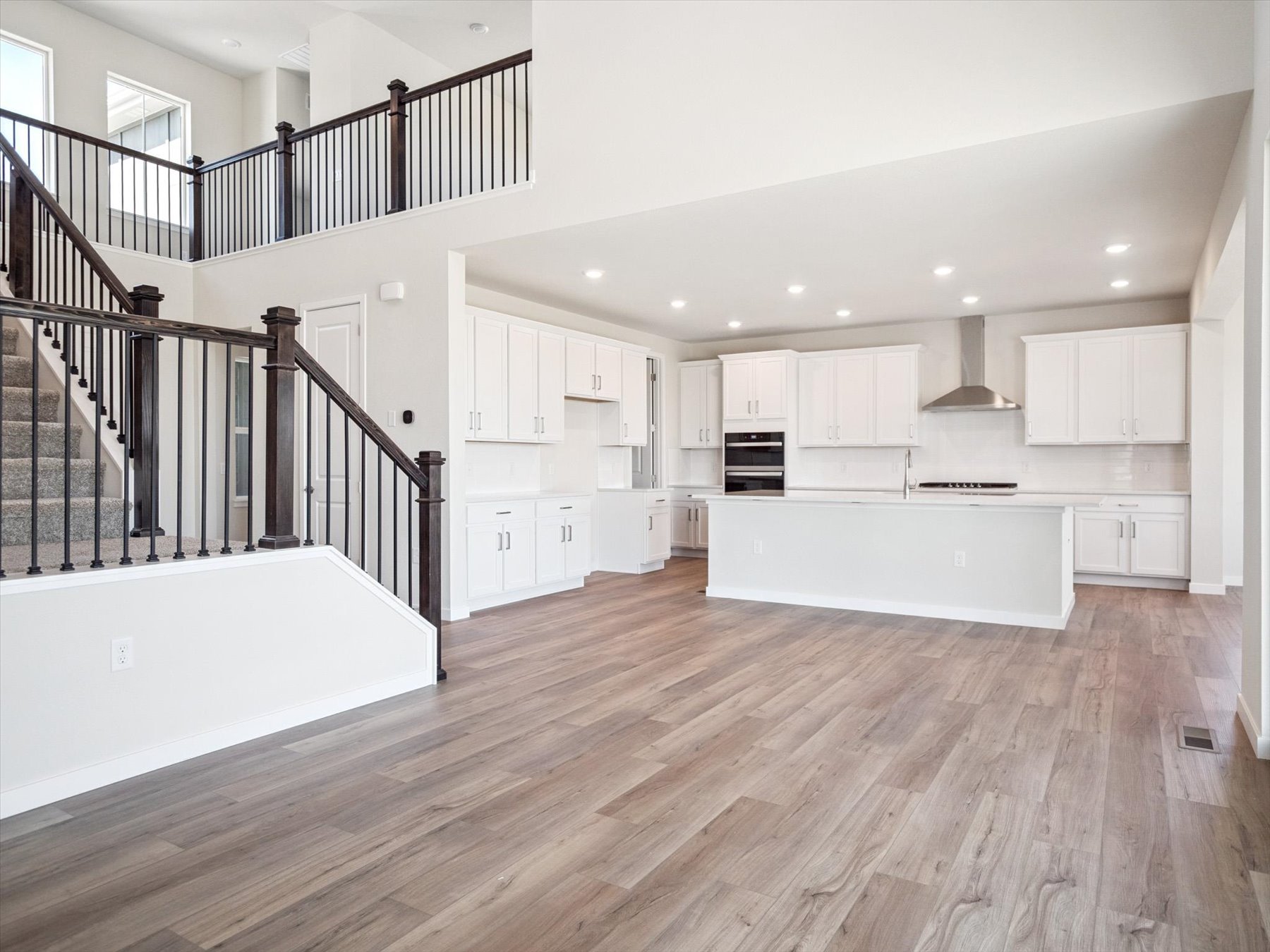 A large white kitchen with white cabinets.