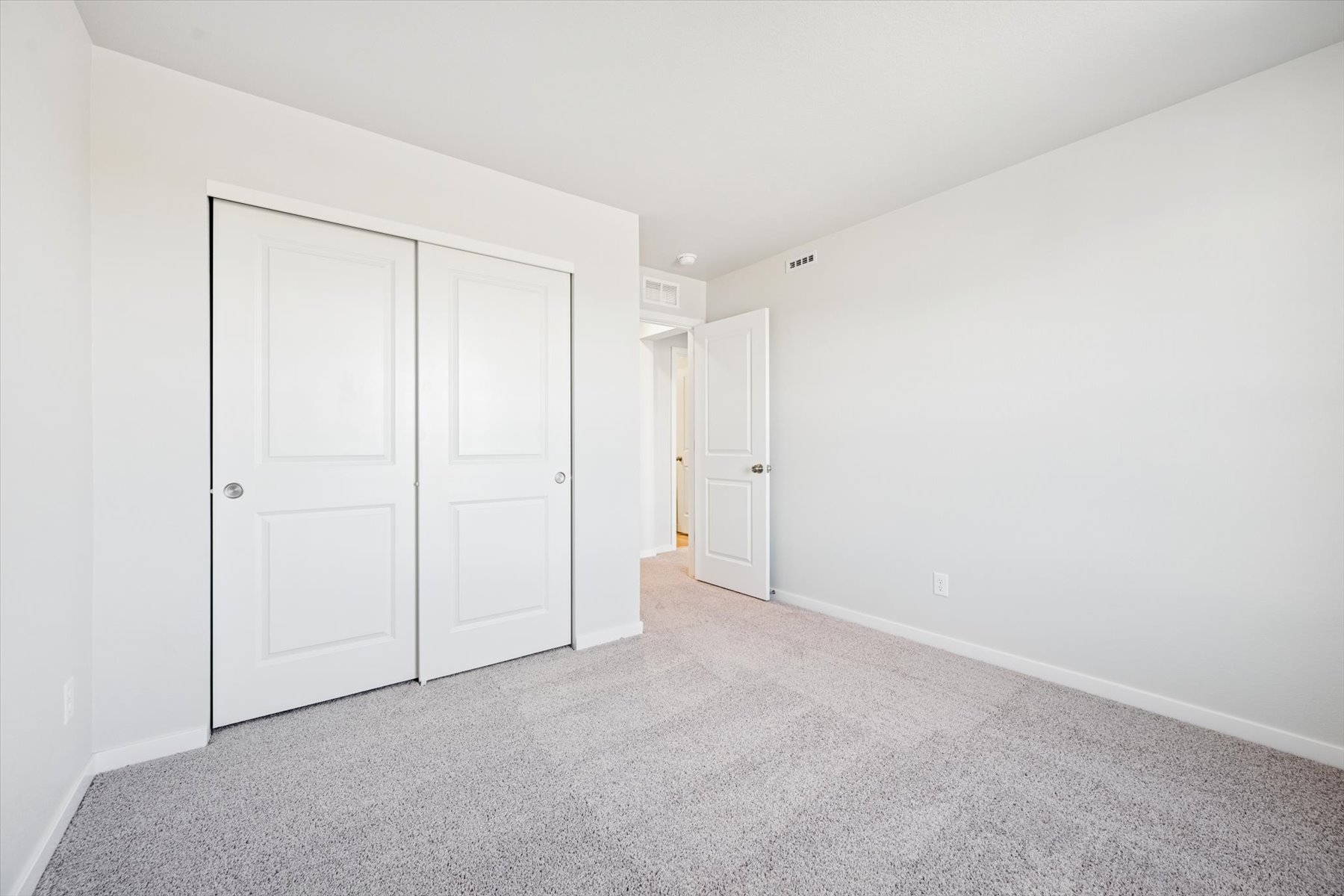 A hallway with white doors.