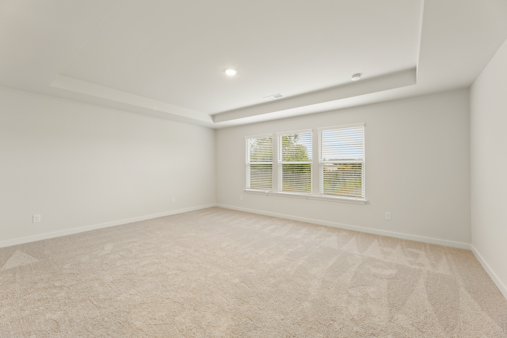A room with a window and a carpet.