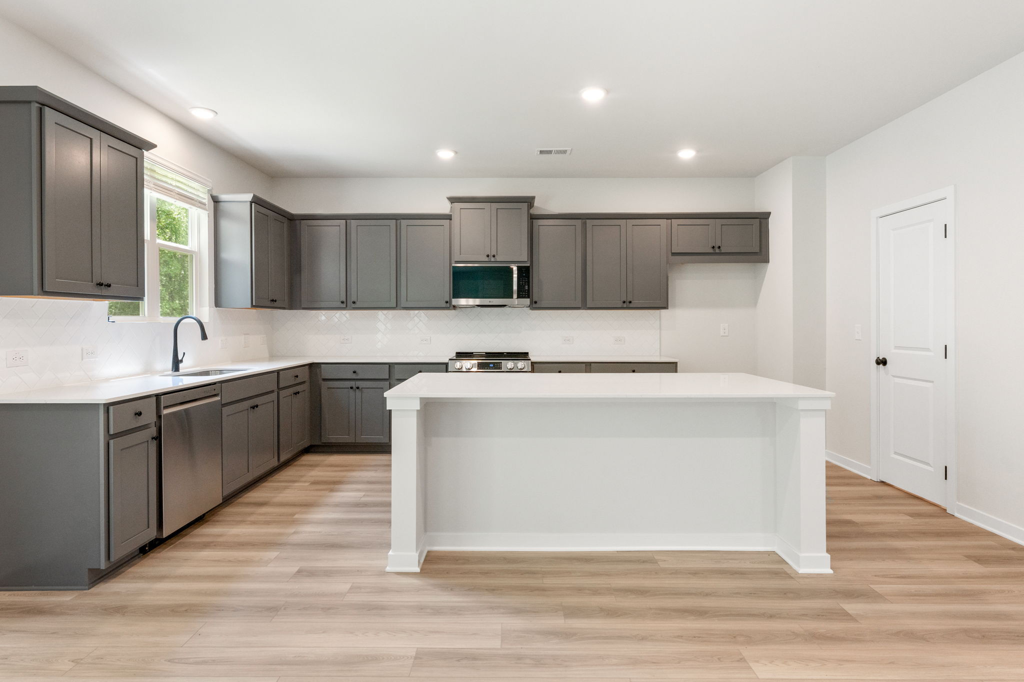 A kitchen with black cabinets.
