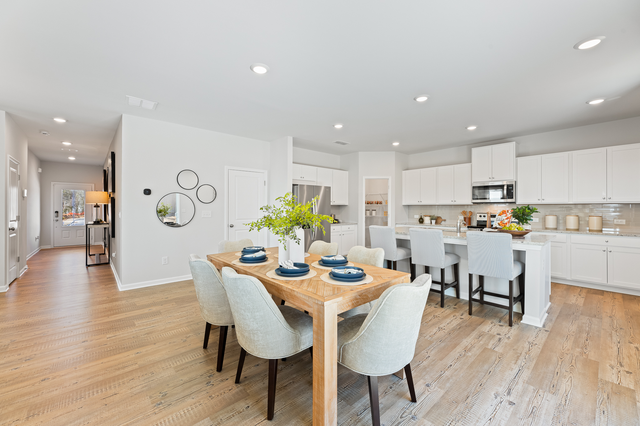 A large kitchen with a dining table.