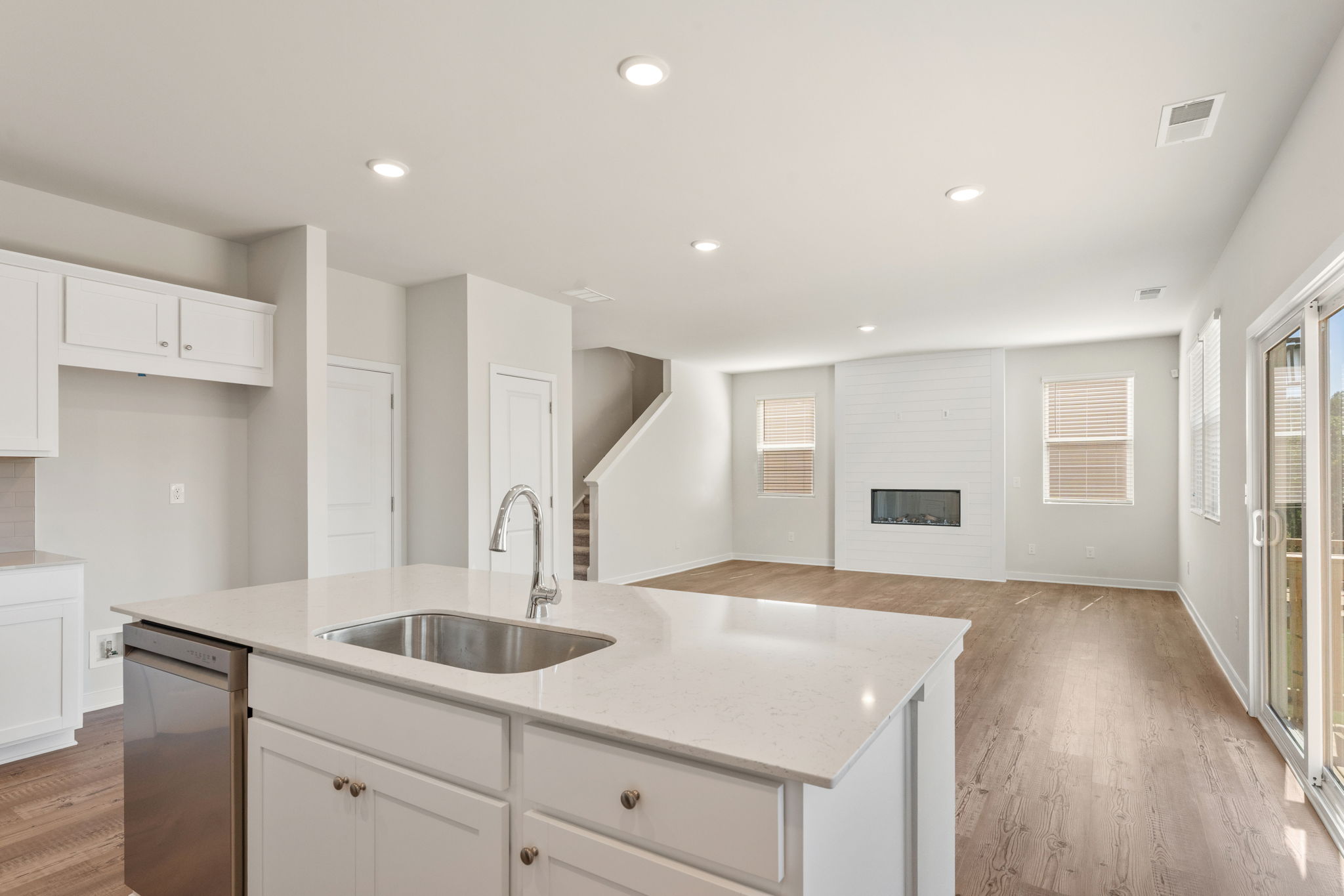 A kitchen with white cabinets.
