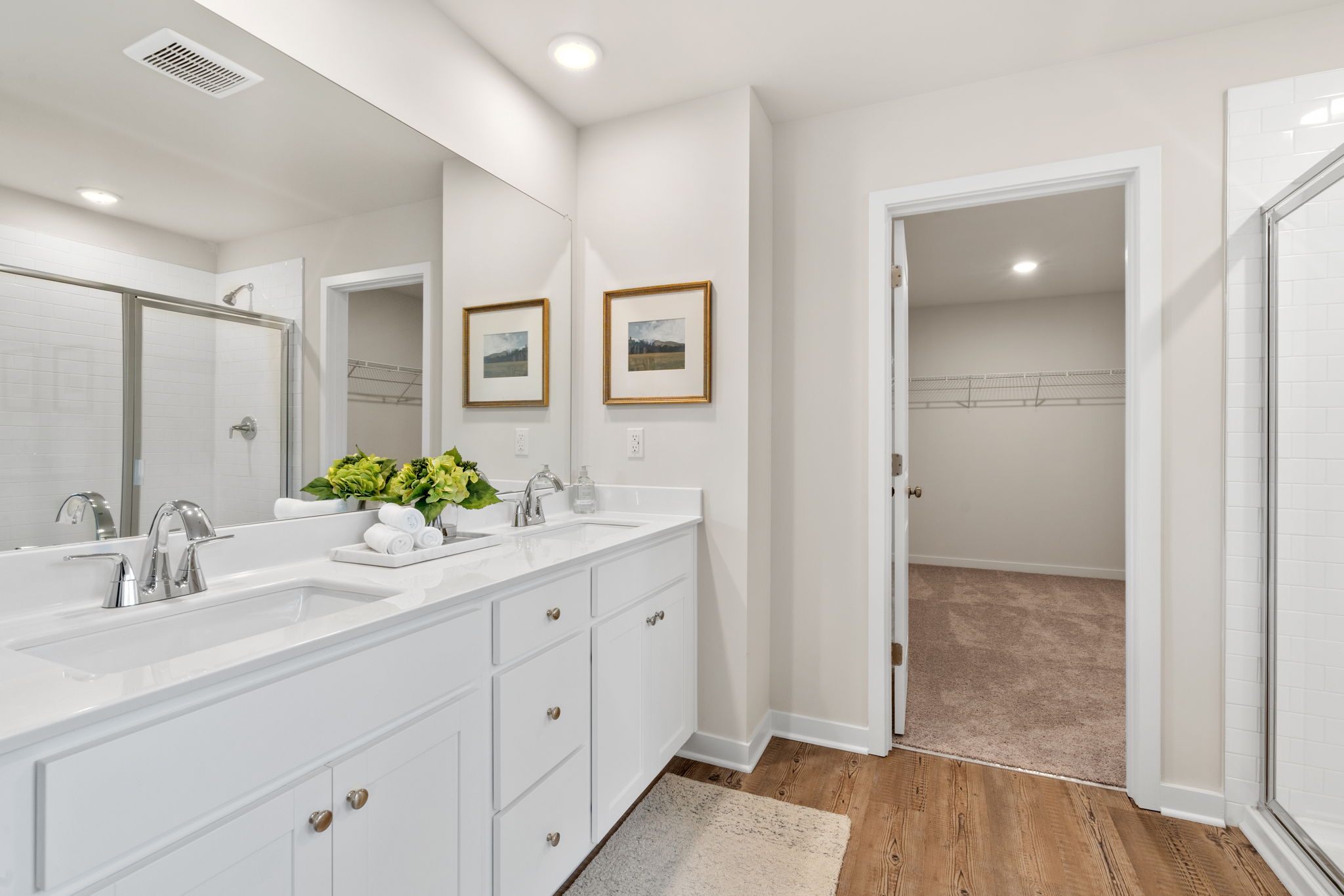 A bathroom with white cabinets.