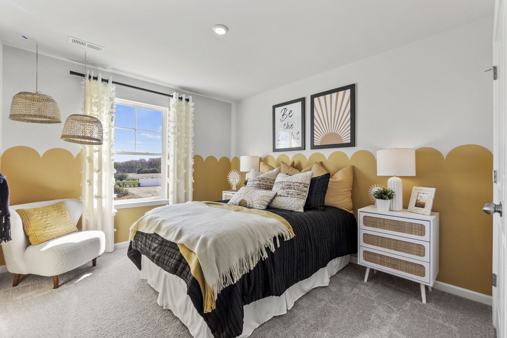 A bedroom with a bed and lamps.