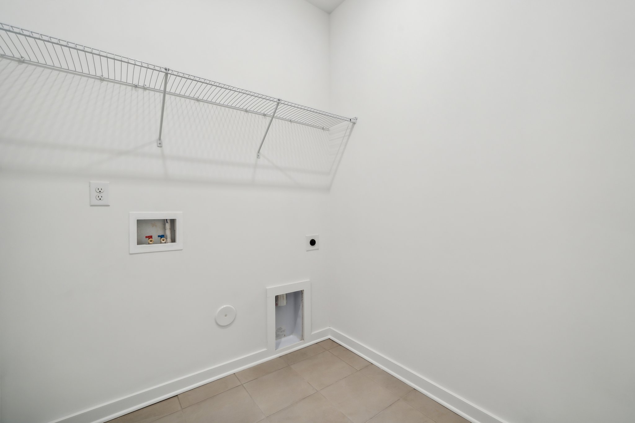 A white room with a tile floor and a white ceiling.