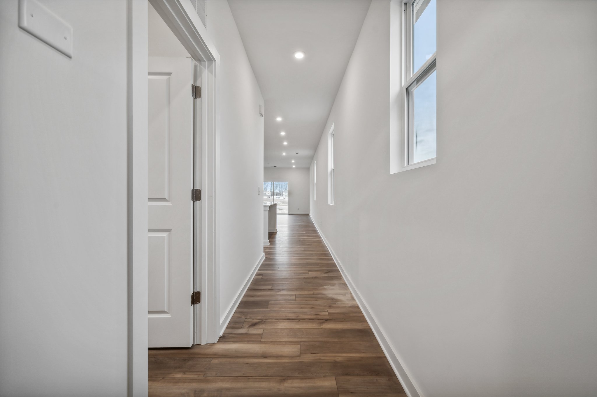 A hallway with white walls.