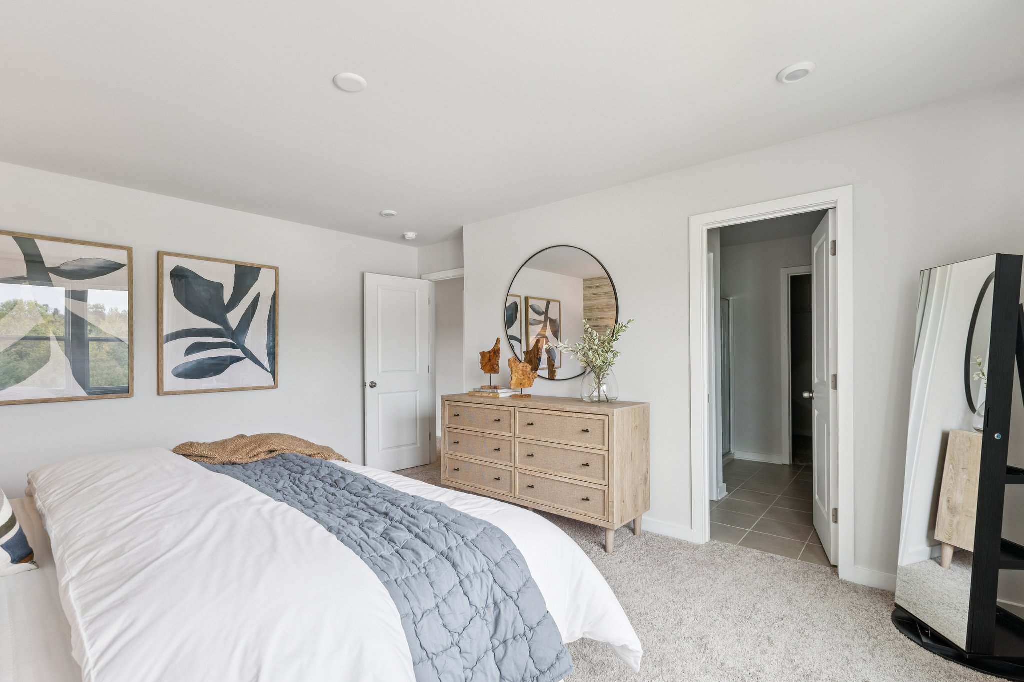 A bedroom with a bed and dresser.